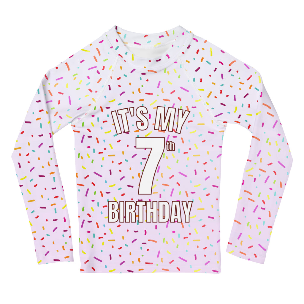 Girls rainbow sprinkles white long-sleeved rash guard swim shirt with colorful pattern and bold birthday text