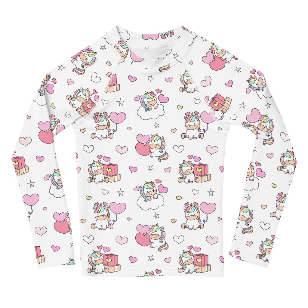 White long-sleeved girls unicorn birthday rash guard swim shirt with playful pastel unicorn print and upf 50+ protection