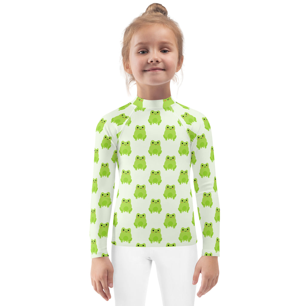 A kids green frog long sleeve rash guard swim shirt with upf 50 plus featuring bright green cartoon frogs on off-white