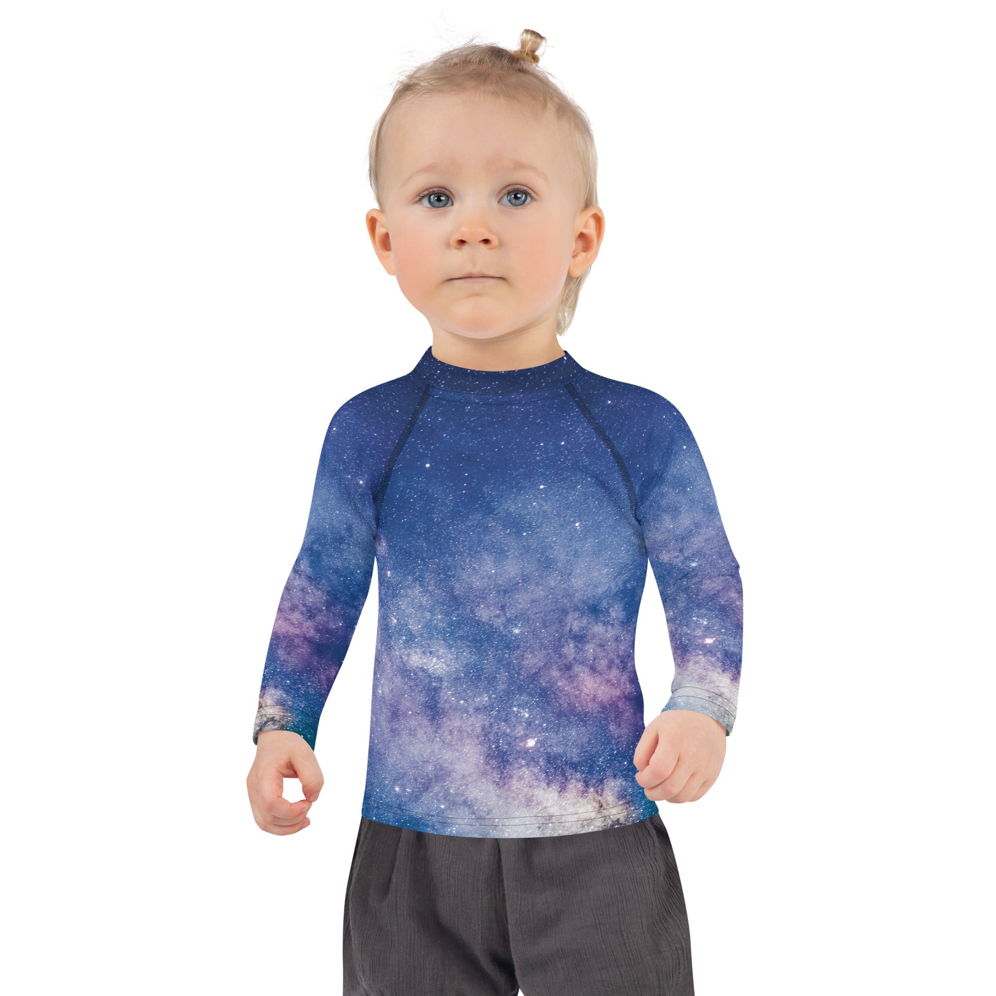 A girl wearing a long-sleeve galaxy print rash guard swim shirt with upf 50 plus sun protection in blue and purple