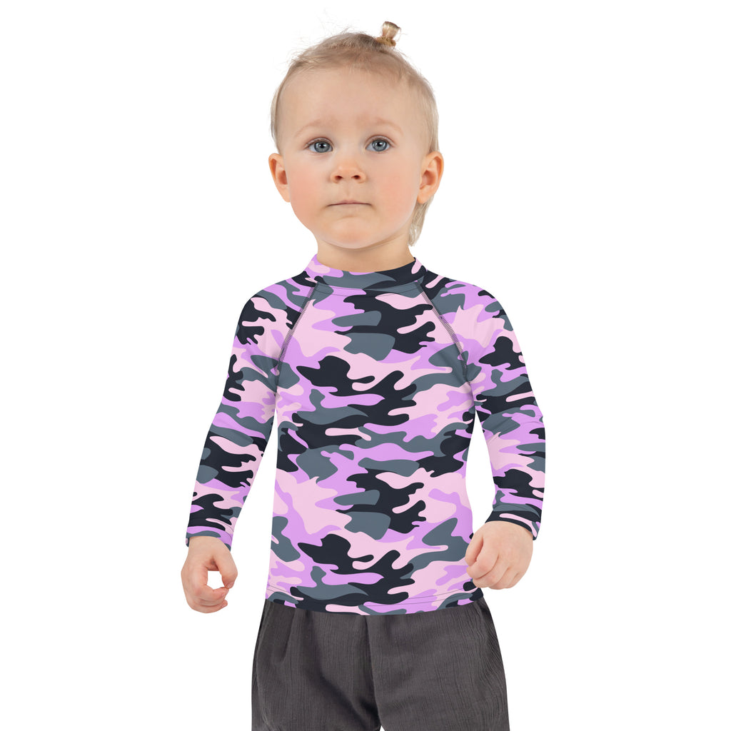 A child wearing a girls purple camouflage long sleeve rash guard swim shirt with upf 50 plus protection