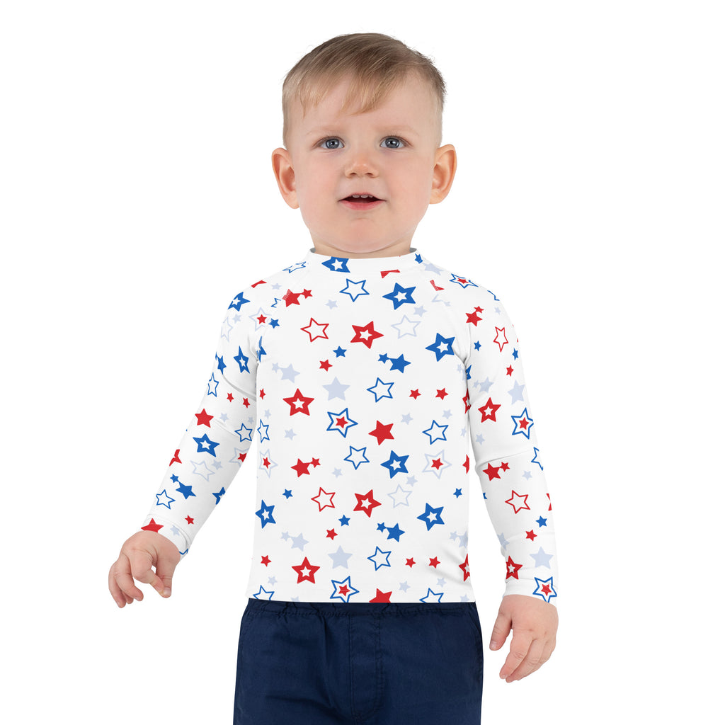 White kids long sleeve rash guard swim shirt with red blue and silver stars and UPF 50 plus sun protection