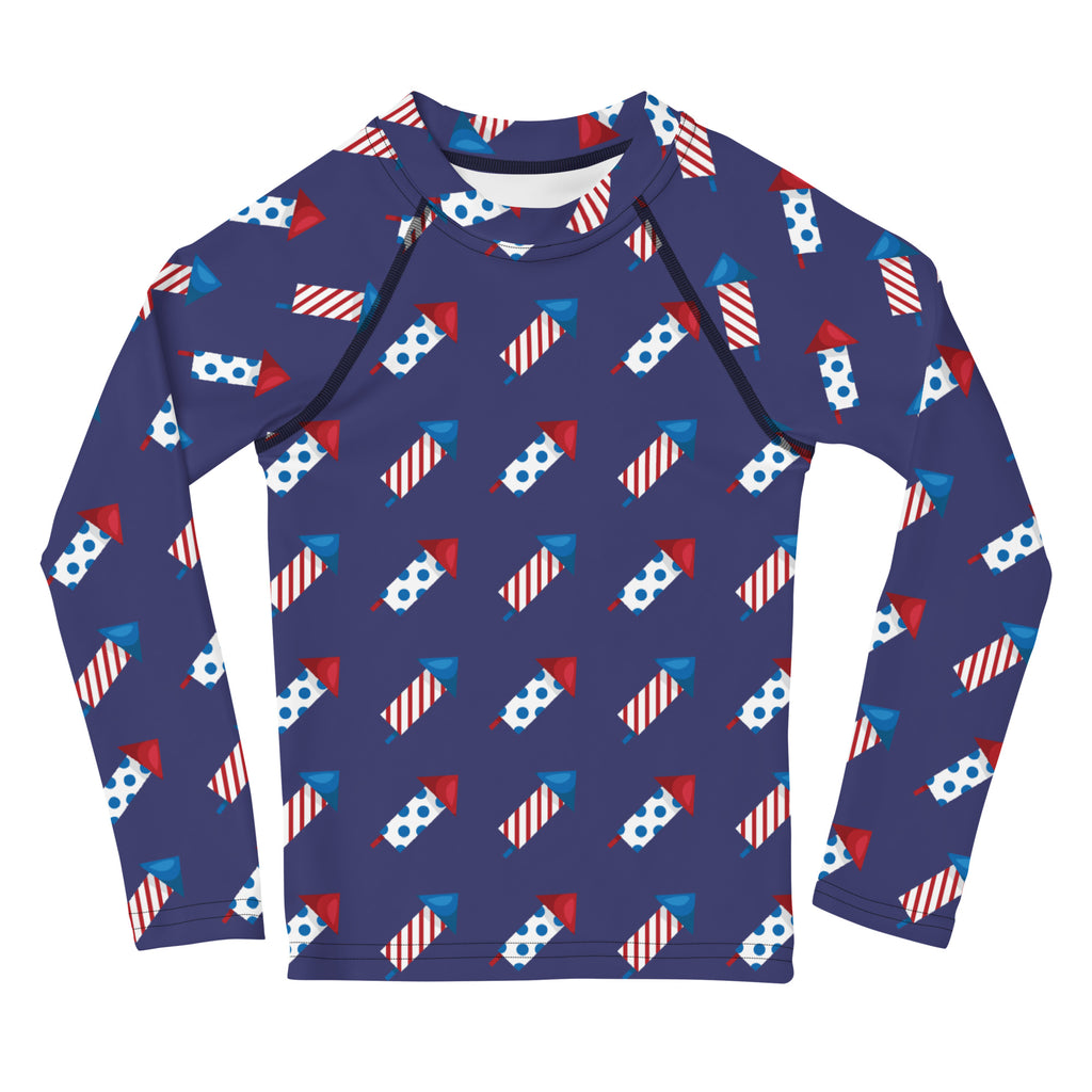Navy blue kids firework rockets long sleeve rash guard swim shirt with red white and blue fireworks pattern and UPF 50+