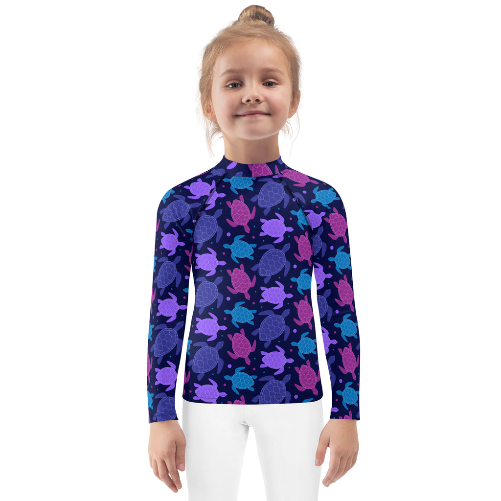 Girls purple sea turtle long sleeve rash guard swim shirt with vibrant pattern on dark navy fabric and UPF 50 plus protection