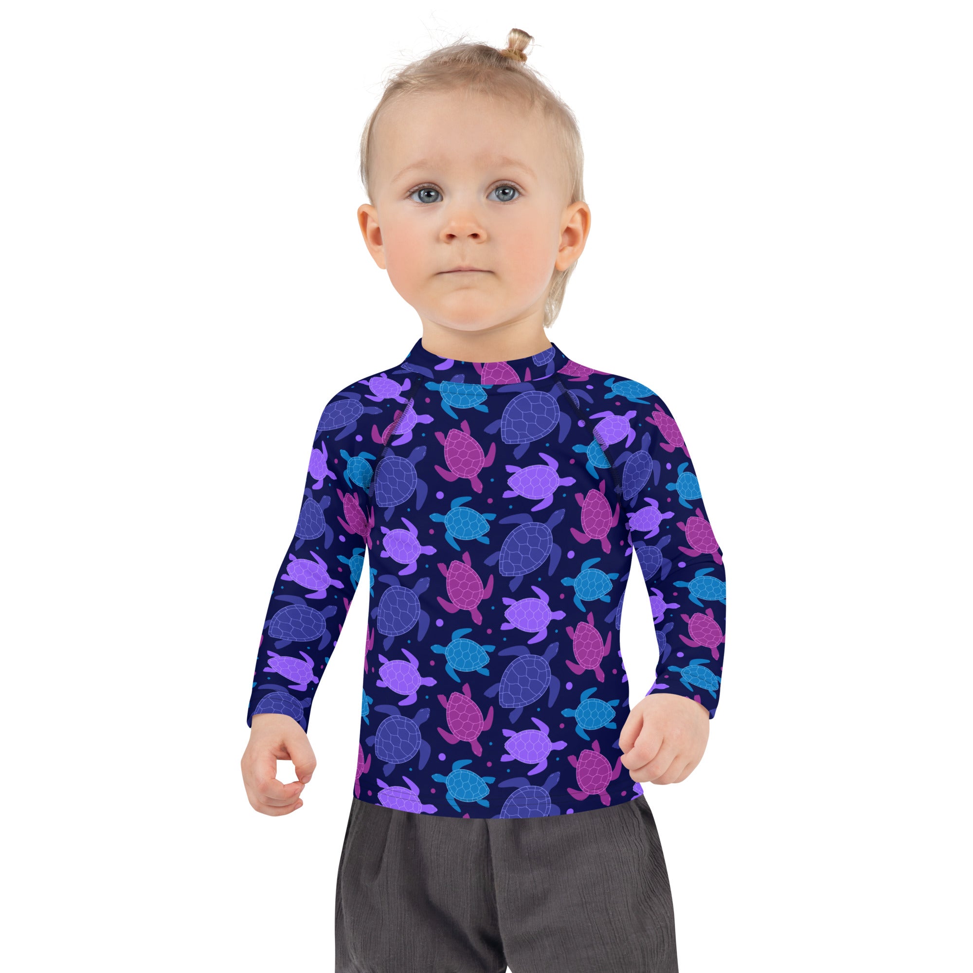 A child wearing a dark navy girls purple sea turtle long sleeve rash guard swim shirt with UPF 50 and colorful turtles