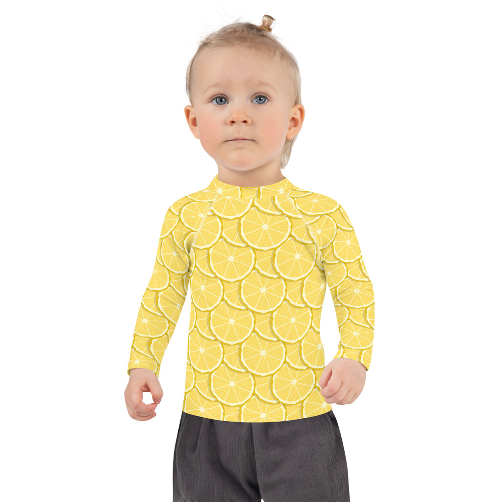 Kids lemon long sleeve rash guard swim shirt in yellow with vibrant overlapping lemon slice pattern and upf 50+ protection