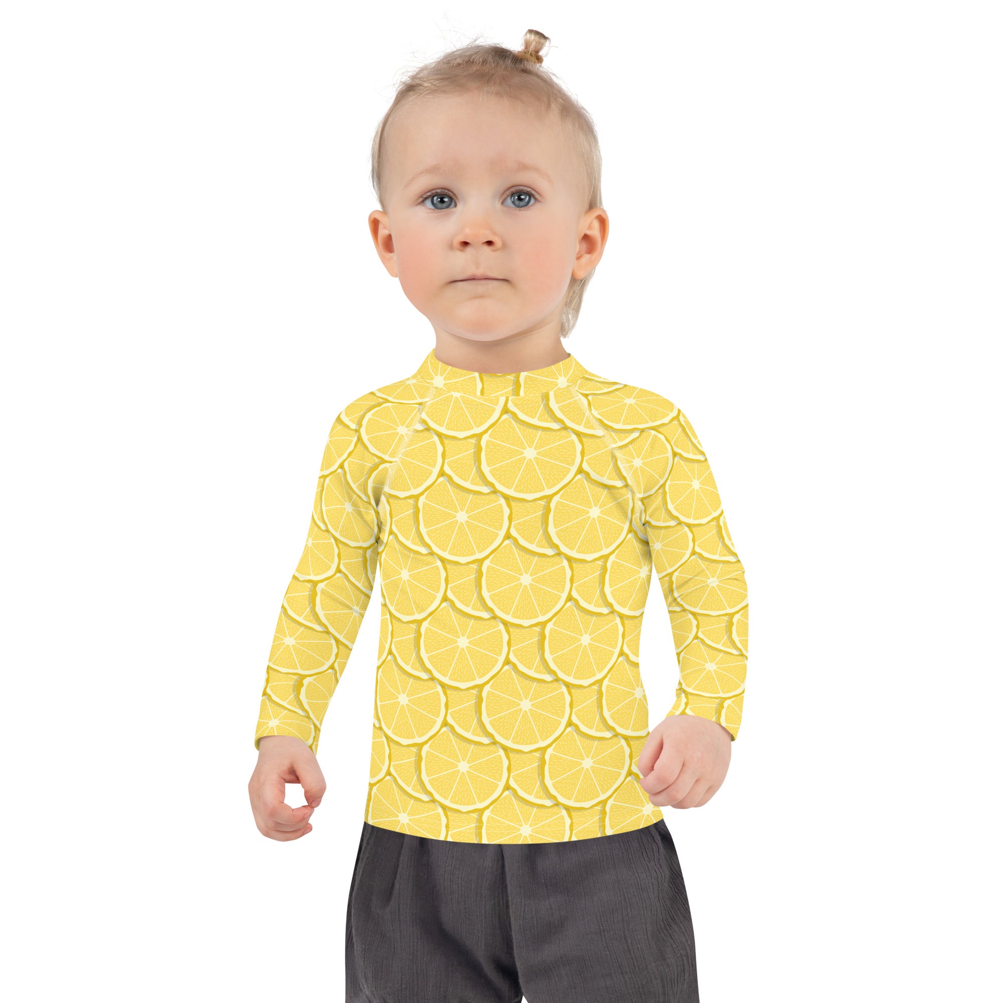 Kids lemon long sleeve rash guard swim shirt in yellow with vibrant overlapping lemon slice pattern and upf 50+ protection