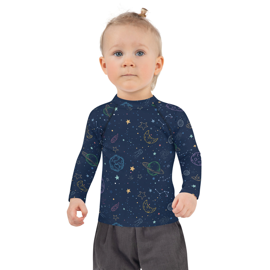 Navy blue kids galaxy long sleeve rash guard swim shirt with upf 50 plus featuring pastel space-themed pattern