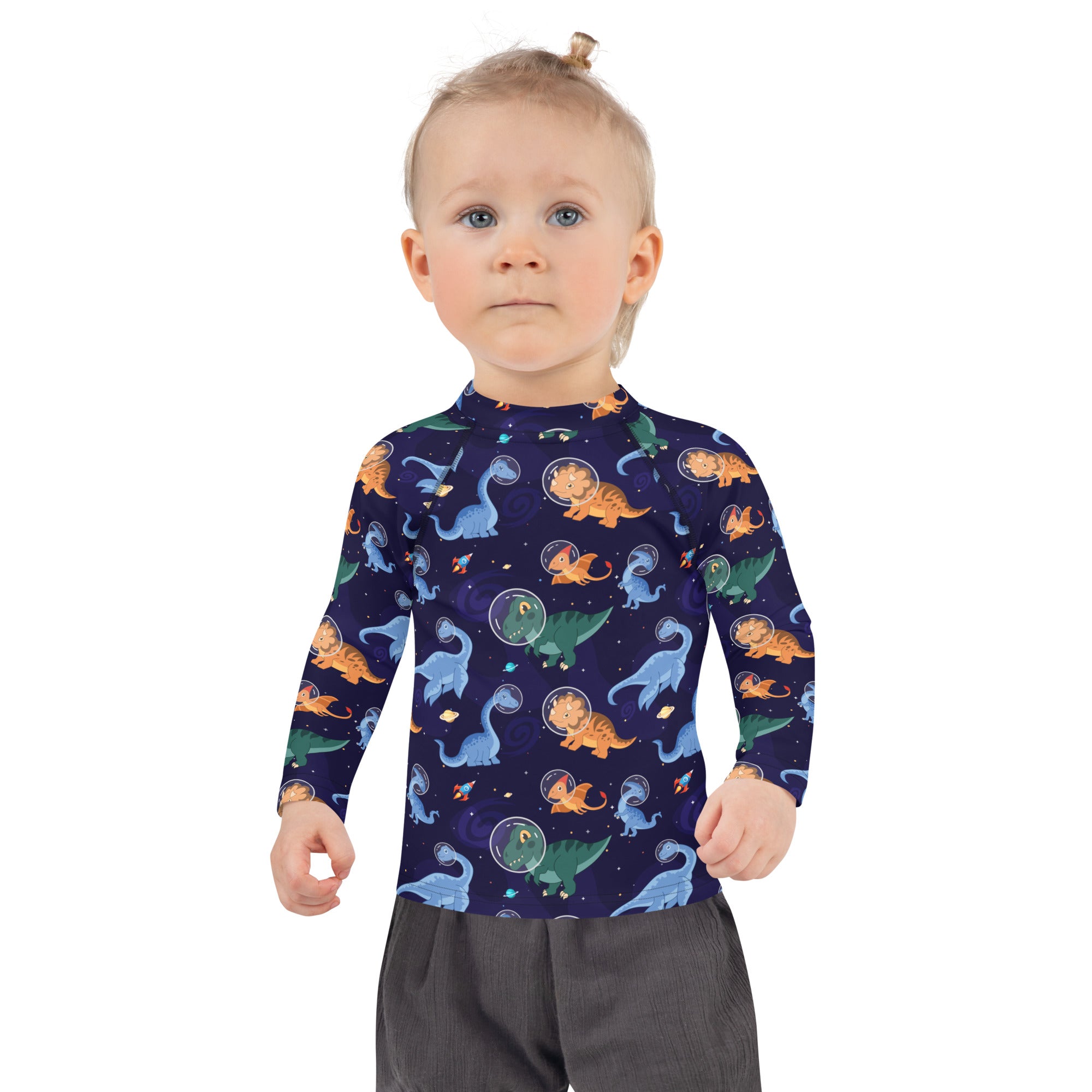 A navy blue kids long sleeve rash guard swim shirt with UPF 50+ featuring cartoon dinosaurs in space pattern