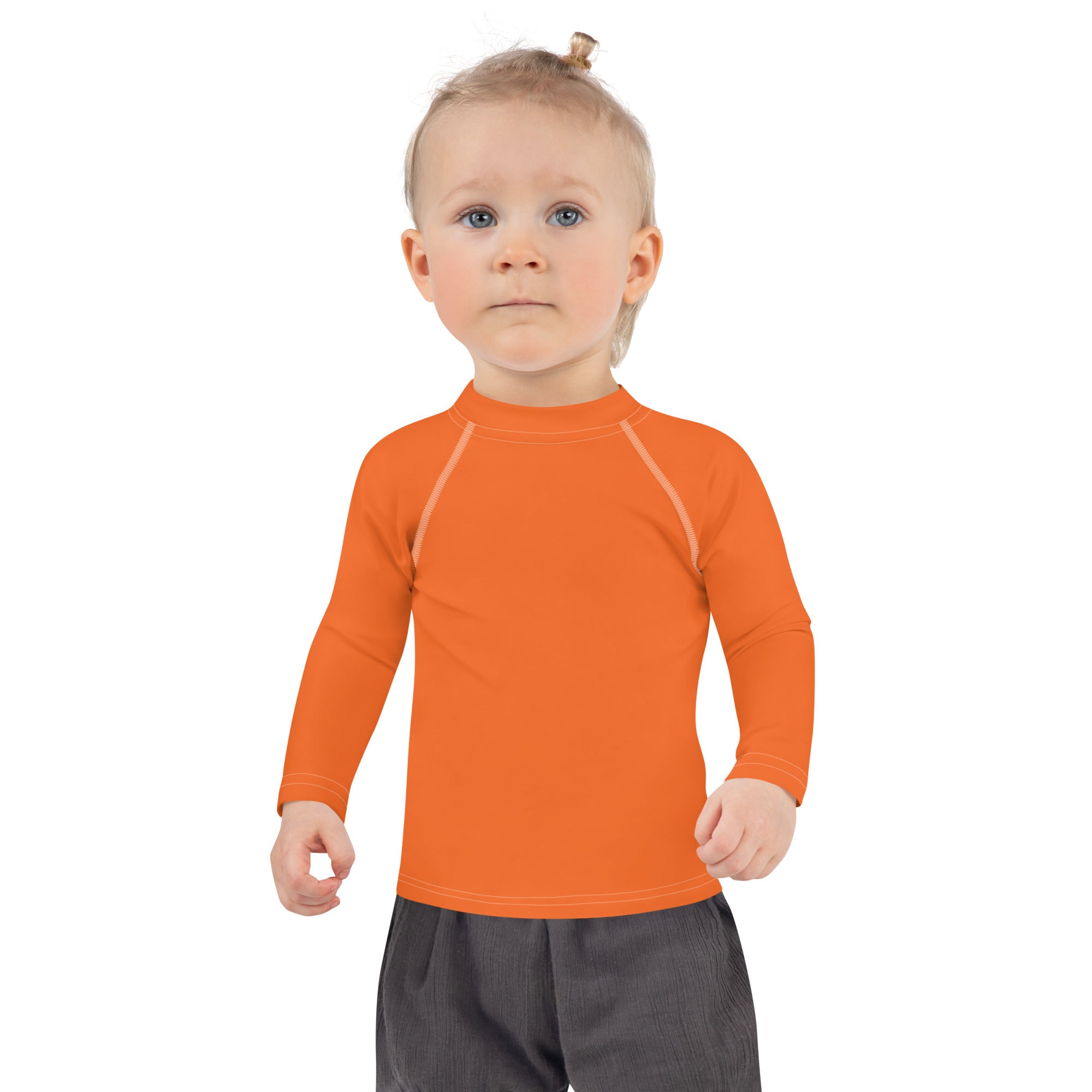Bright orange kids long sleeve rash guard swim shirt with subtle white seams and UPF 50 plus sun protection