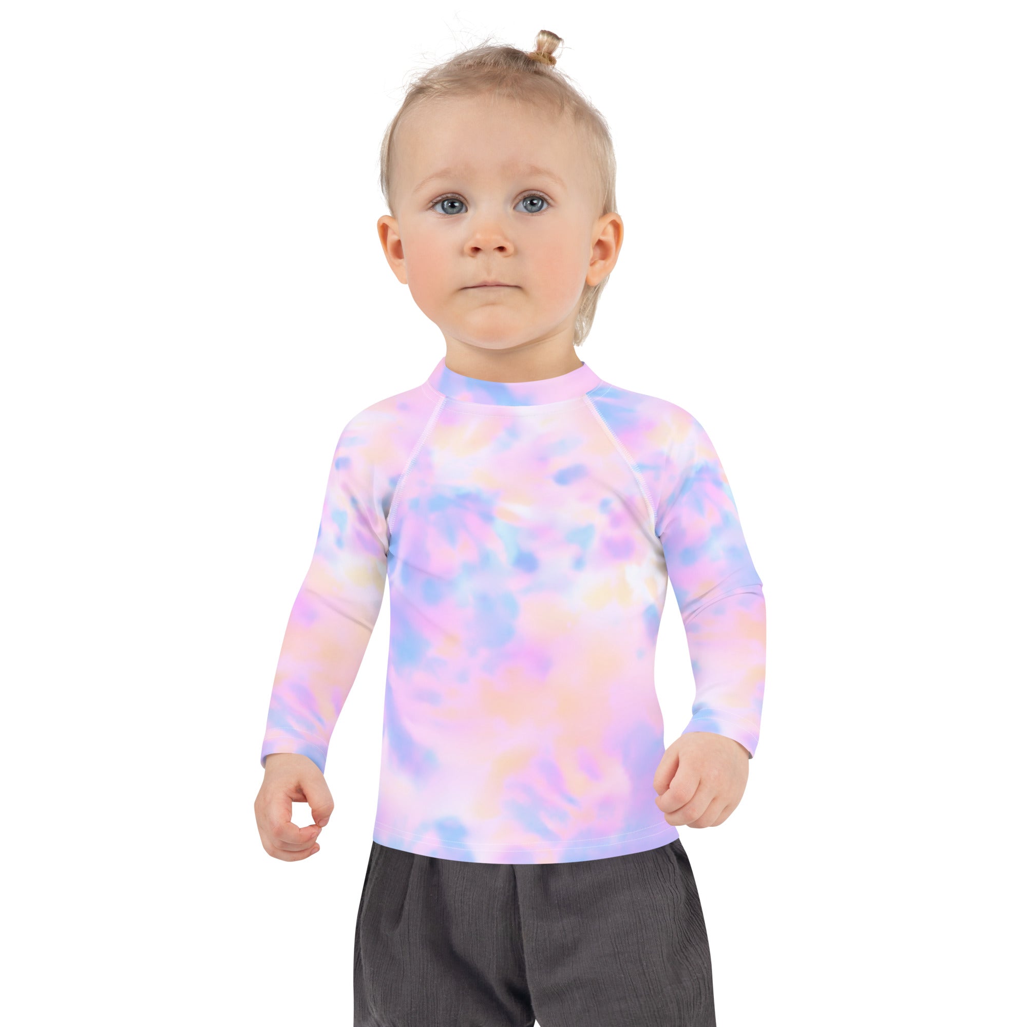 A girl wearing a pastel watercolor long sleeve rash guard swim shirt with upf 50 plus in lavender pink and blue