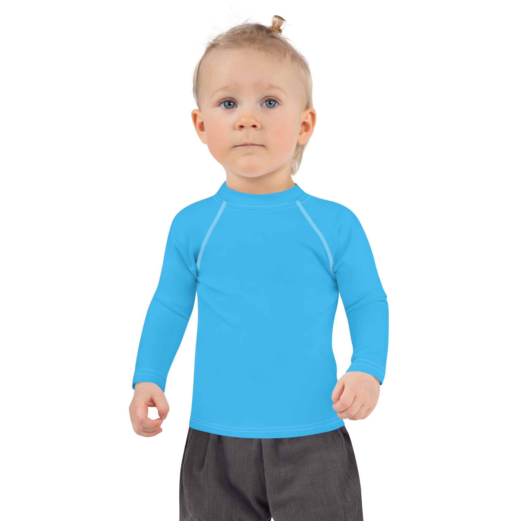 Bright blue kids long sleeve rash guard swim shirt with subtle white seams and UPF 50 plus sun protection