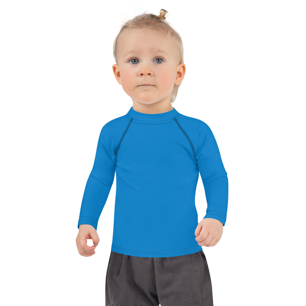 Kids navy blue long sleeve rash guard swim shirt with upf 50 and bright blue fabric with high collar and dark seam details