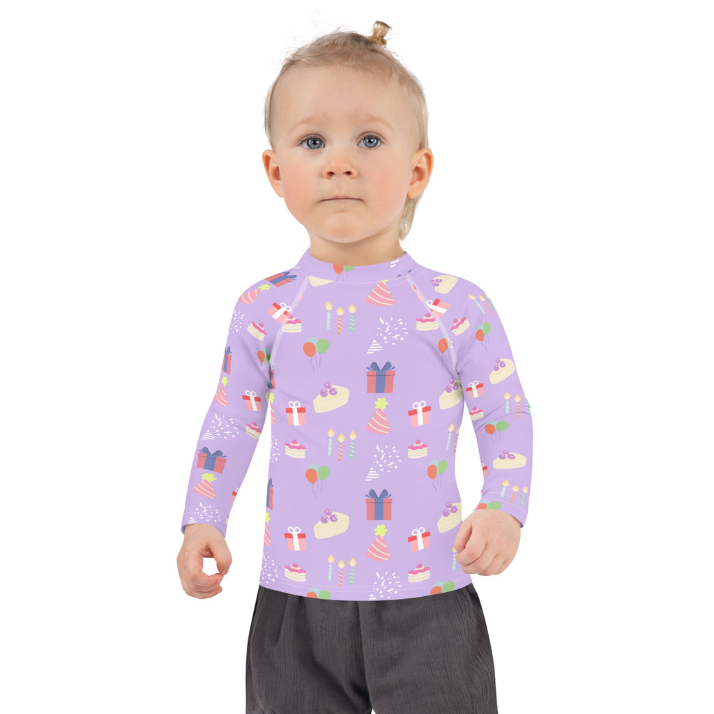 Lavender girls birthday party rash guard swim shirt with playful cake pattern and UPF 50 plus sun protection