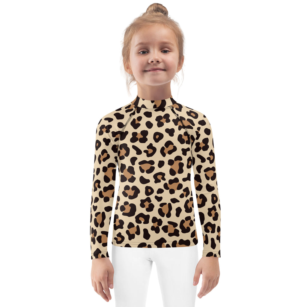 A child wearing a beige and brown leopard print kids long sleeve rash guard swim shirt with UPF 50 plus protection