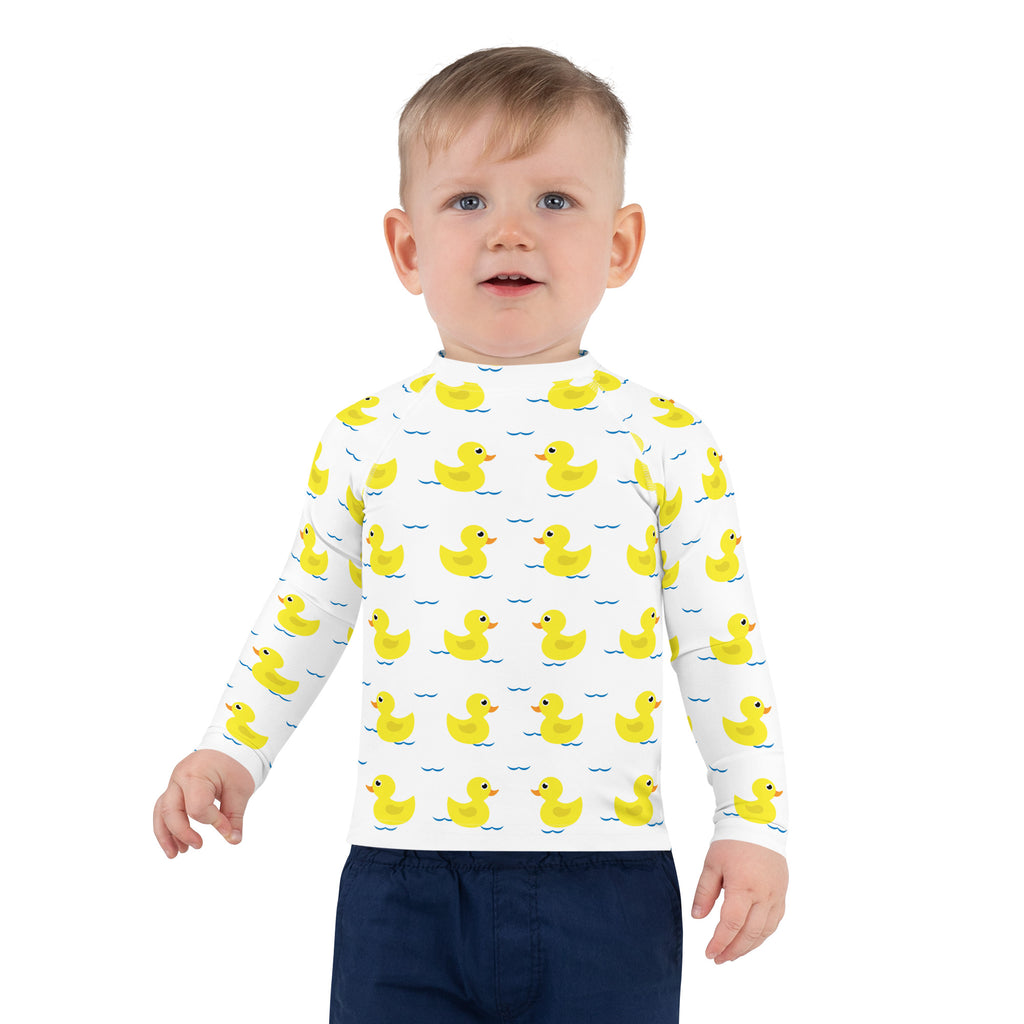 White long sleeve kids rash guard swim shirt with yellow duck pattern and upf 50+ protection on blue wavy lines