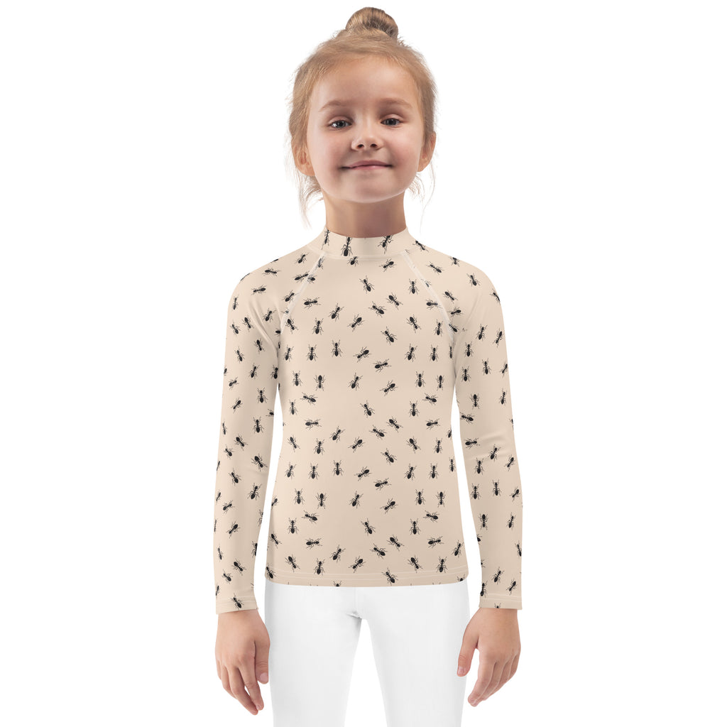 Beige kids long-sleeve high-neck rash guard swim shirt with black ant pattern and UPF 50 plus sun protection
