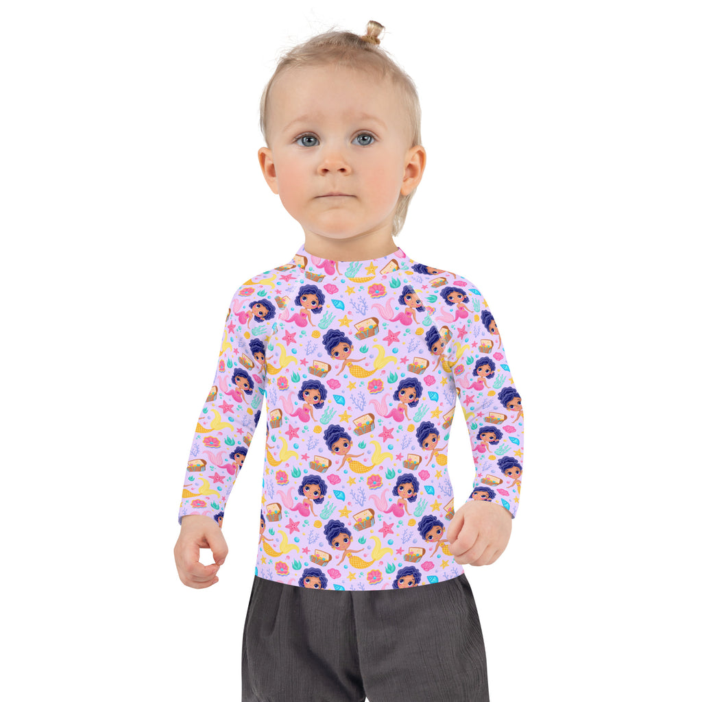 A child wearing a light purple girls mermaid adventure long sleeve rash guard with UPF 50 plus featuring cartoon mermaids and starfish