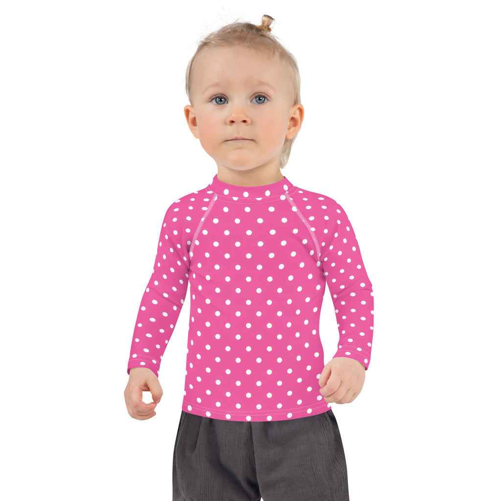 Girls pink long sleeve rash guard swim shirt with white polka dots and UPF 50 plus for sun protection