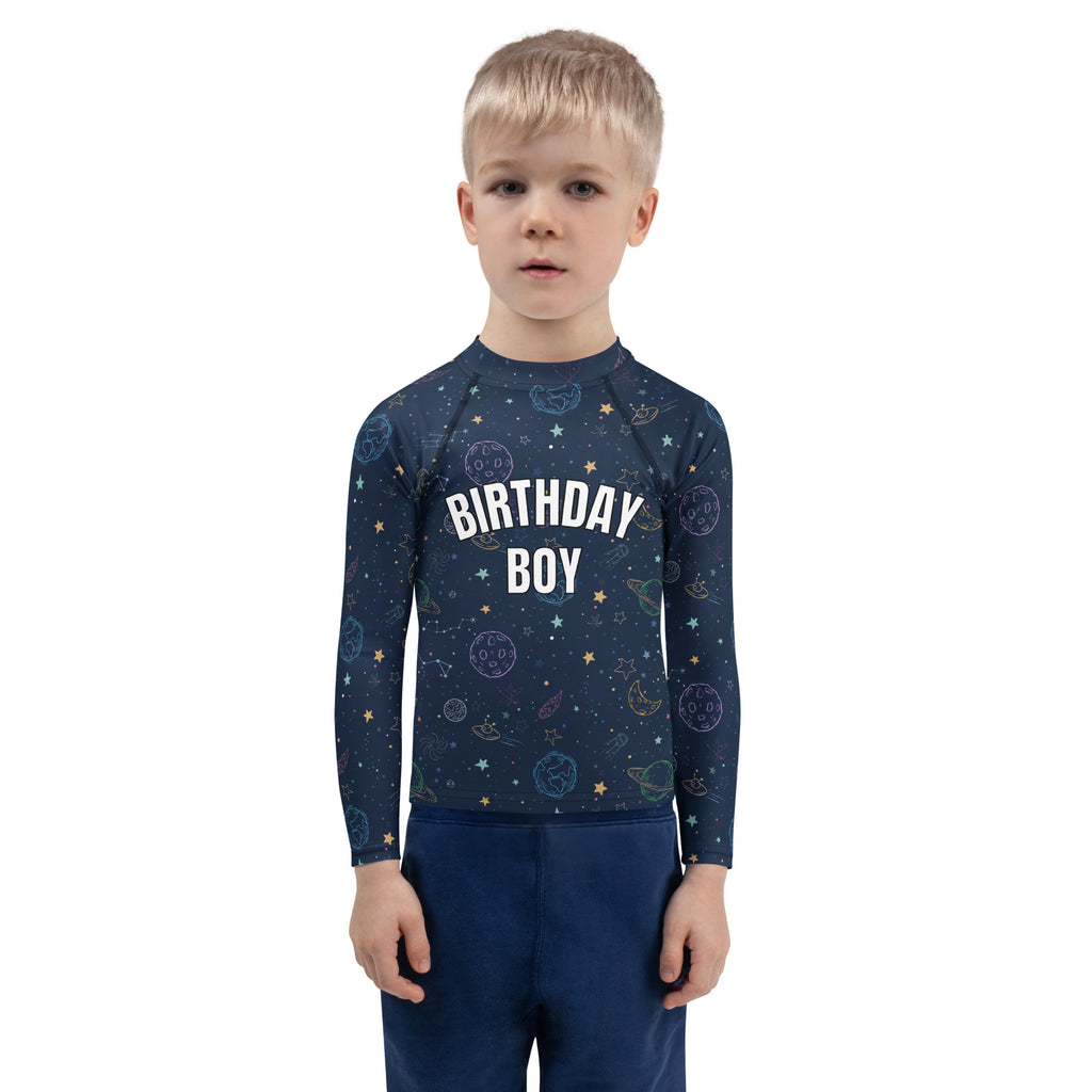 Navy blue long-sleeved rash guard swim shirt with white birthday boy text and colorful galaxy space pattern with UPF 50+