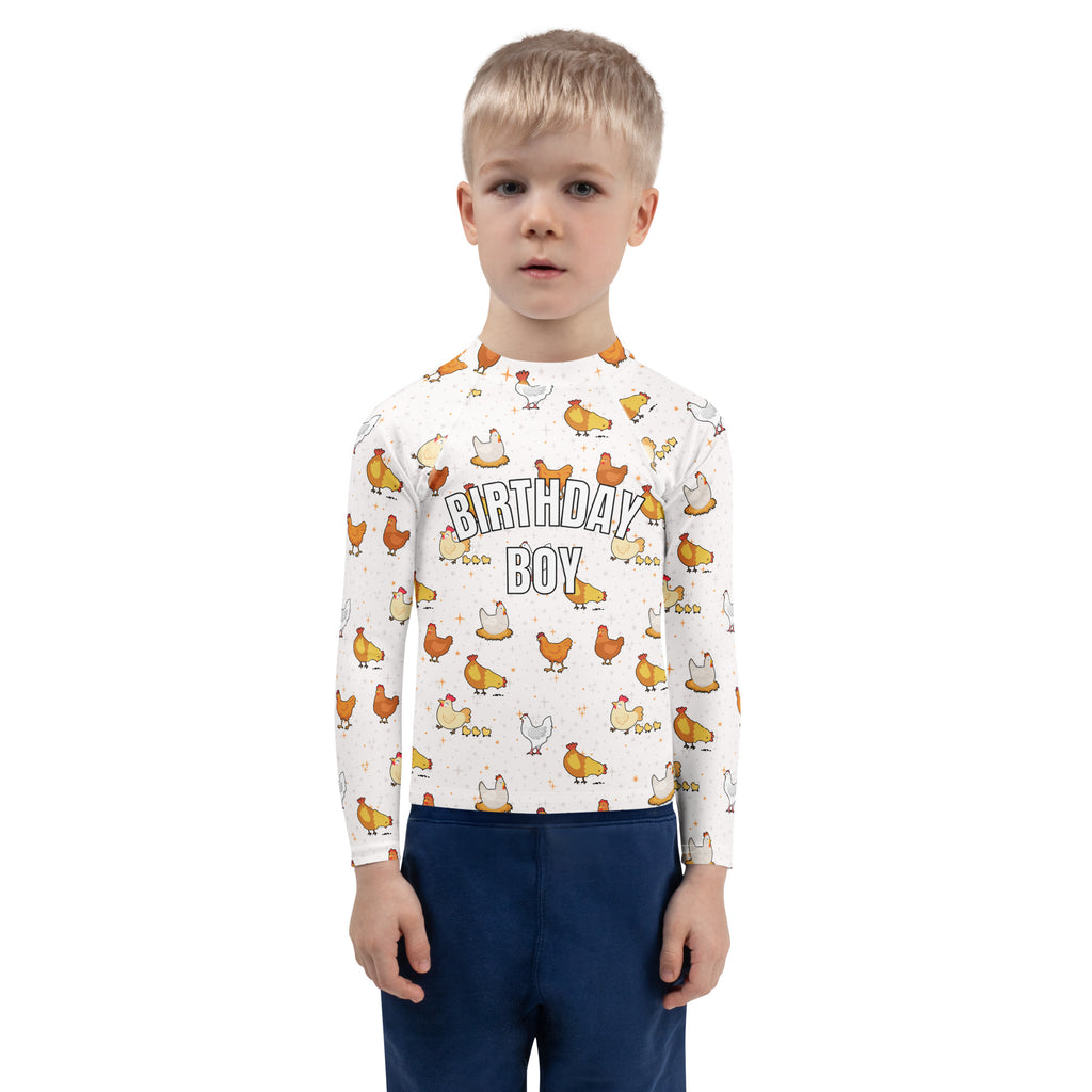 White long sleeve rash guard swim shirt with playful orange and white chicken pattern and birthday boy text