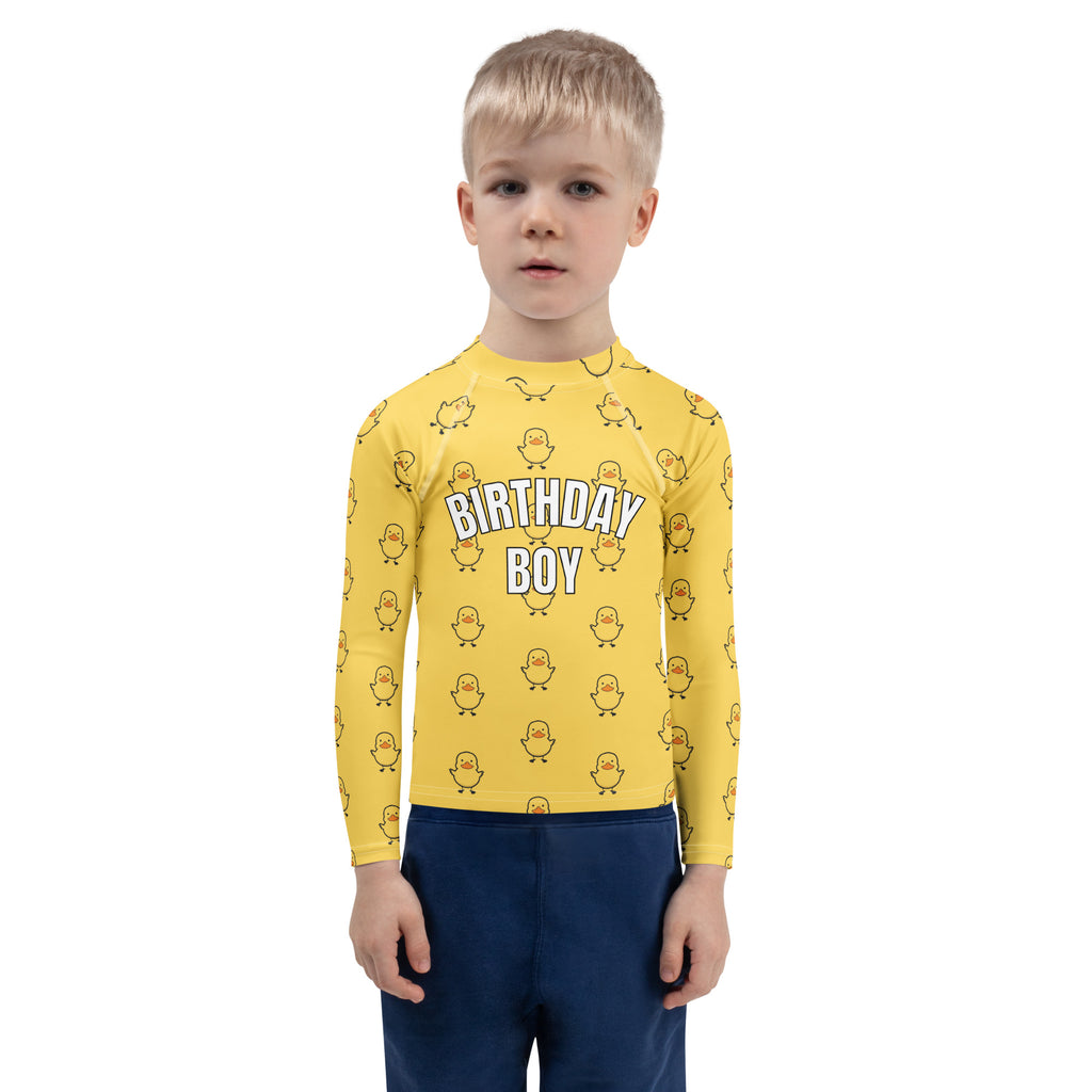 Yellow long sleeve rash guard swim shirt with rubber duck pattern and birthday boy lettering with UPF 50 plus protection