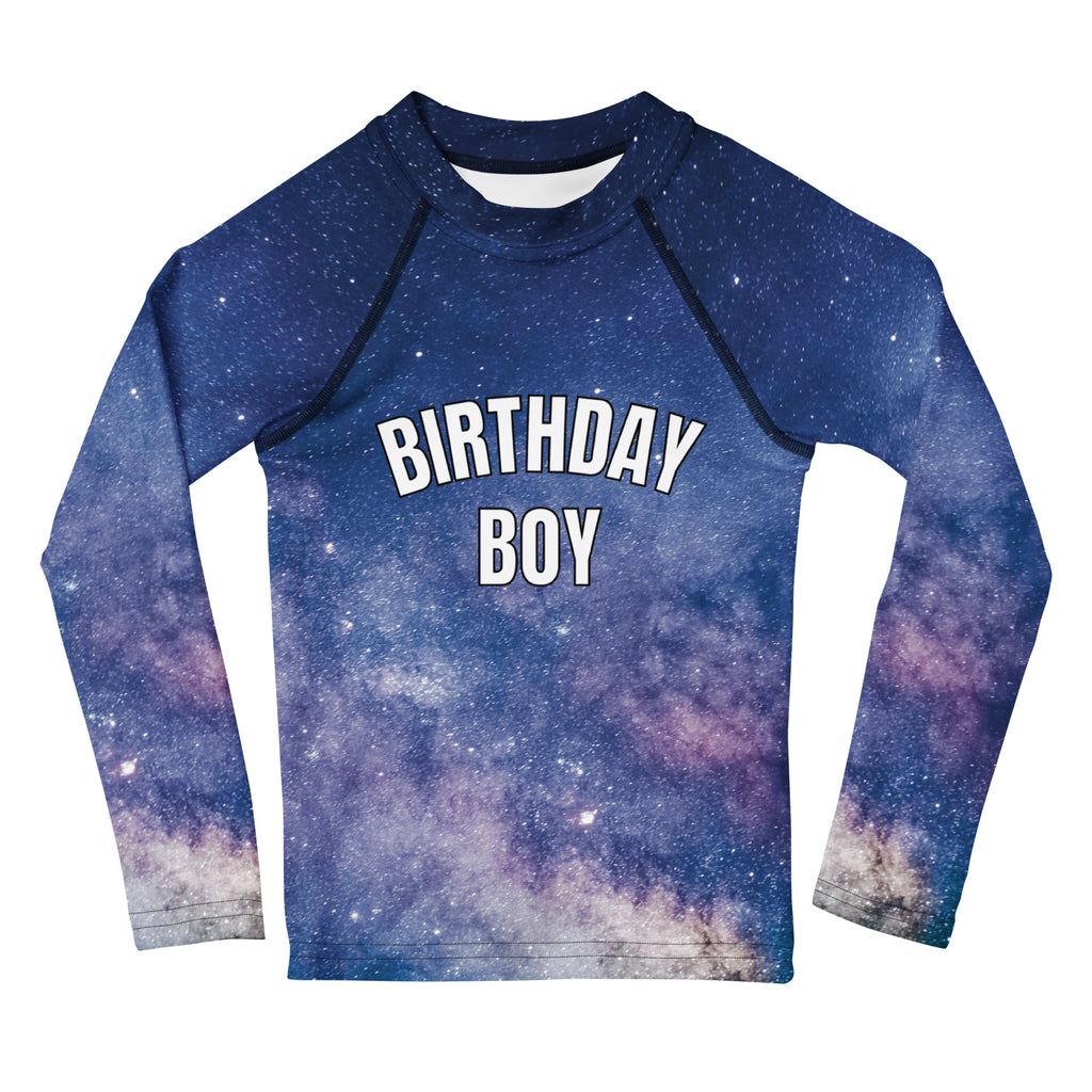 A navy blue long sleeve rash guard with a purple white galaxy print and bold white birthday boy lettering with UPF 50+