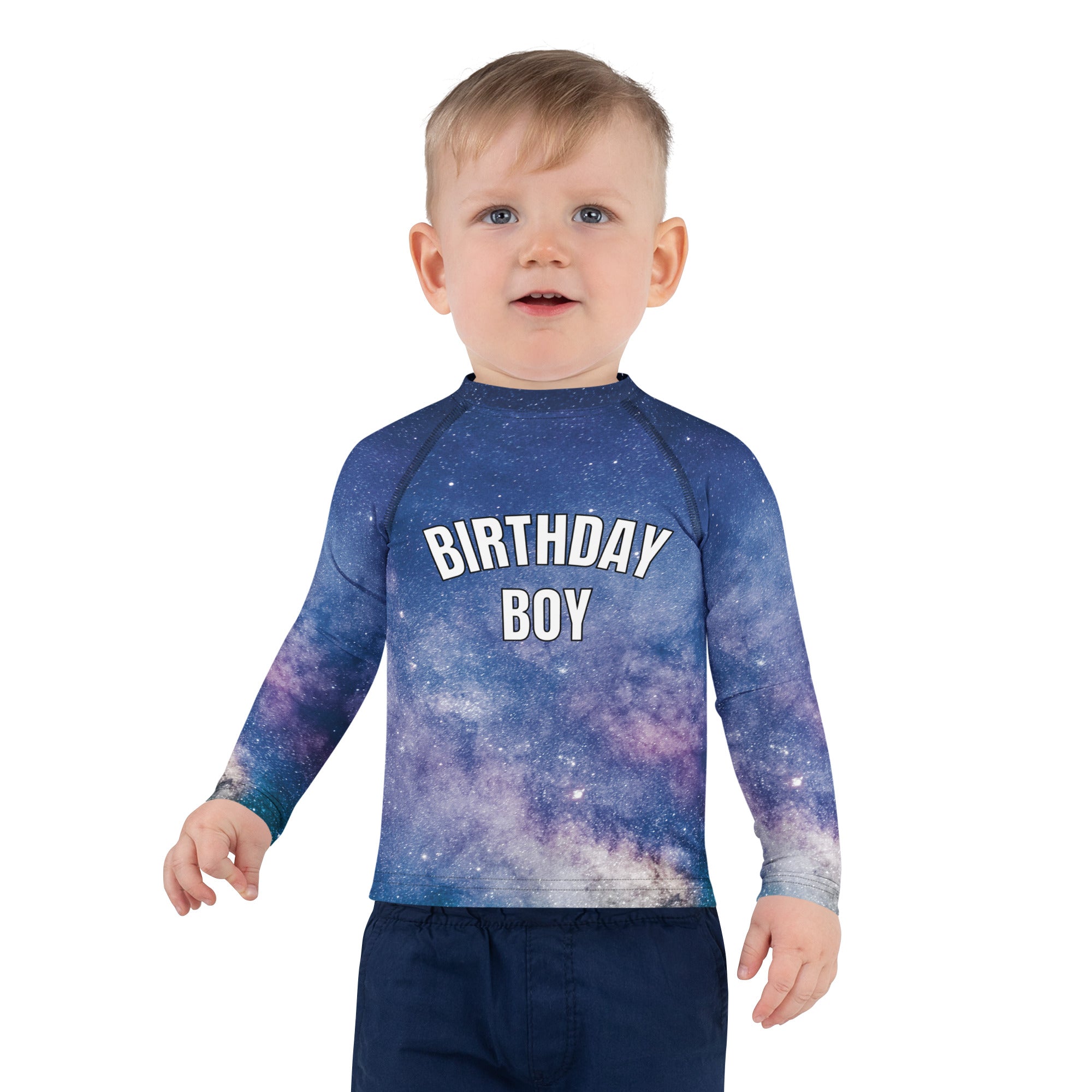 A child wearing a birthday boy realistic galaxy long sleeve rash guard swim shirt with upf 50 plus in blue and purple