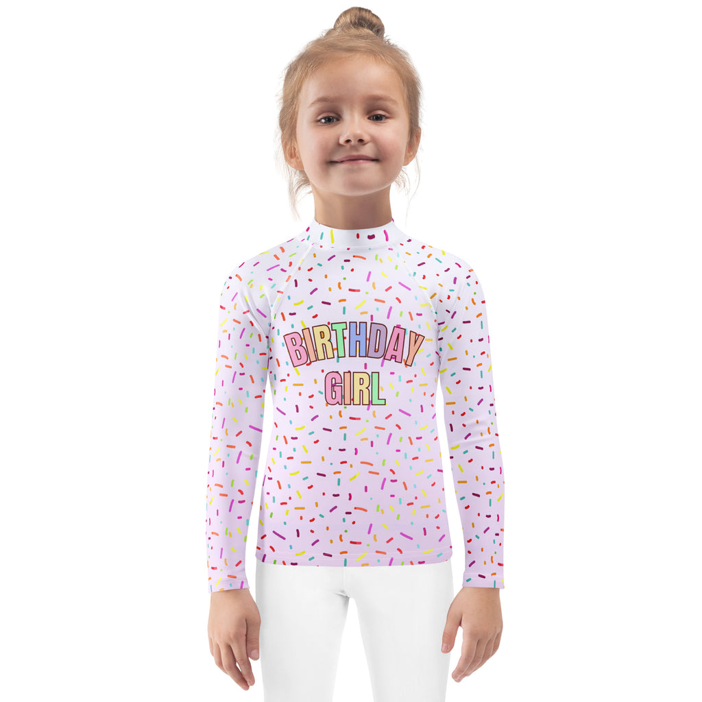 White long sleeve rash guard swim shirt with colorful rainbow sprinkles and birthday girl text with upf 50+ protection