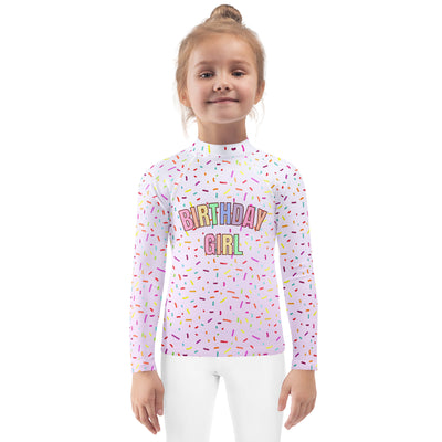 White long sleeve rash guard swim shirt with colorful rainbow sprinkles and birthday girl text with upf 50+ protection