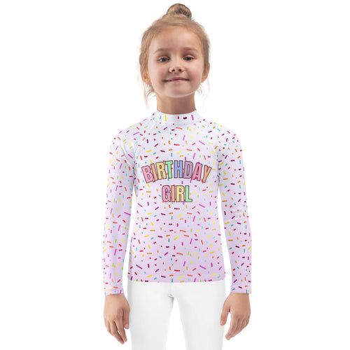 White long sleeve rash guard swim shirt with colorful rainbow sprinkles and birthday girl text with upf 50+ protection