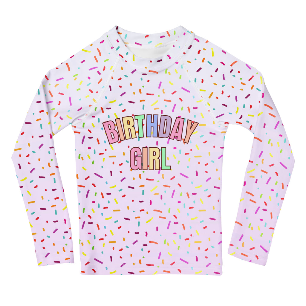 White long-sleeved rash guard swim shirt with colorful sprinkles and birthday girl rainbow print with upf 50+ protection
