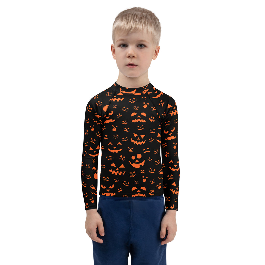 Black long-sleeved rash guard with vibrant orange jack-o-lantern faces for kids with UPF 50 plus sun protection