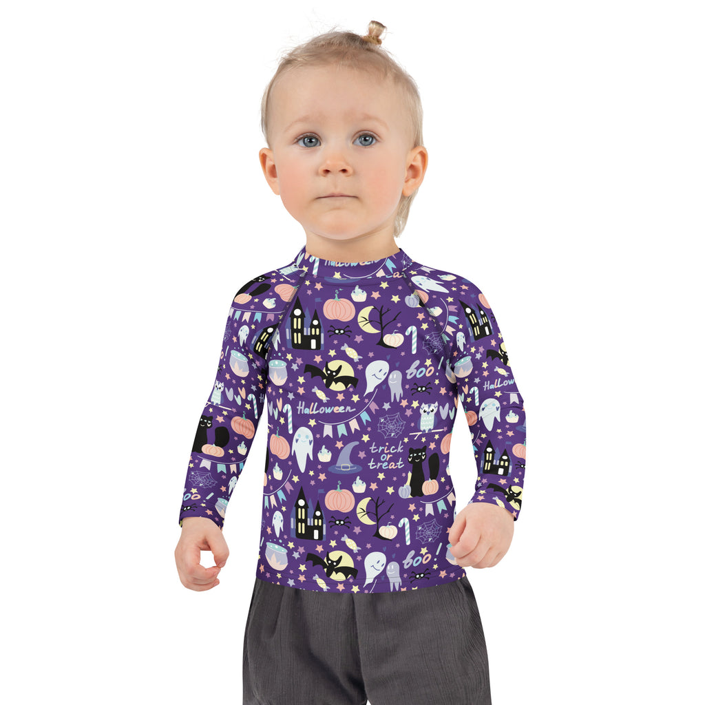 Purple kids spooky halloween long sleeve rash guard swim shirt with black white and orange cartoon graphics and upf 50+