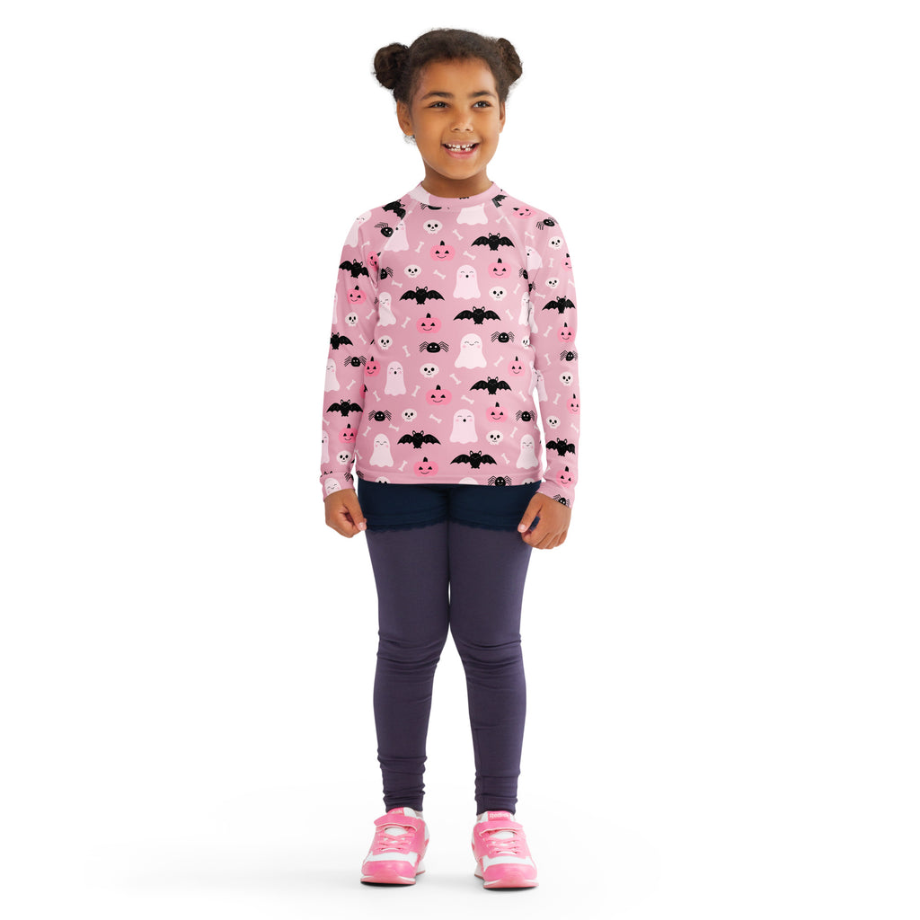Girls pink long-sleeved halloween rash guard swim shirt with black bats white ghosts print and upf 50 plus protection
