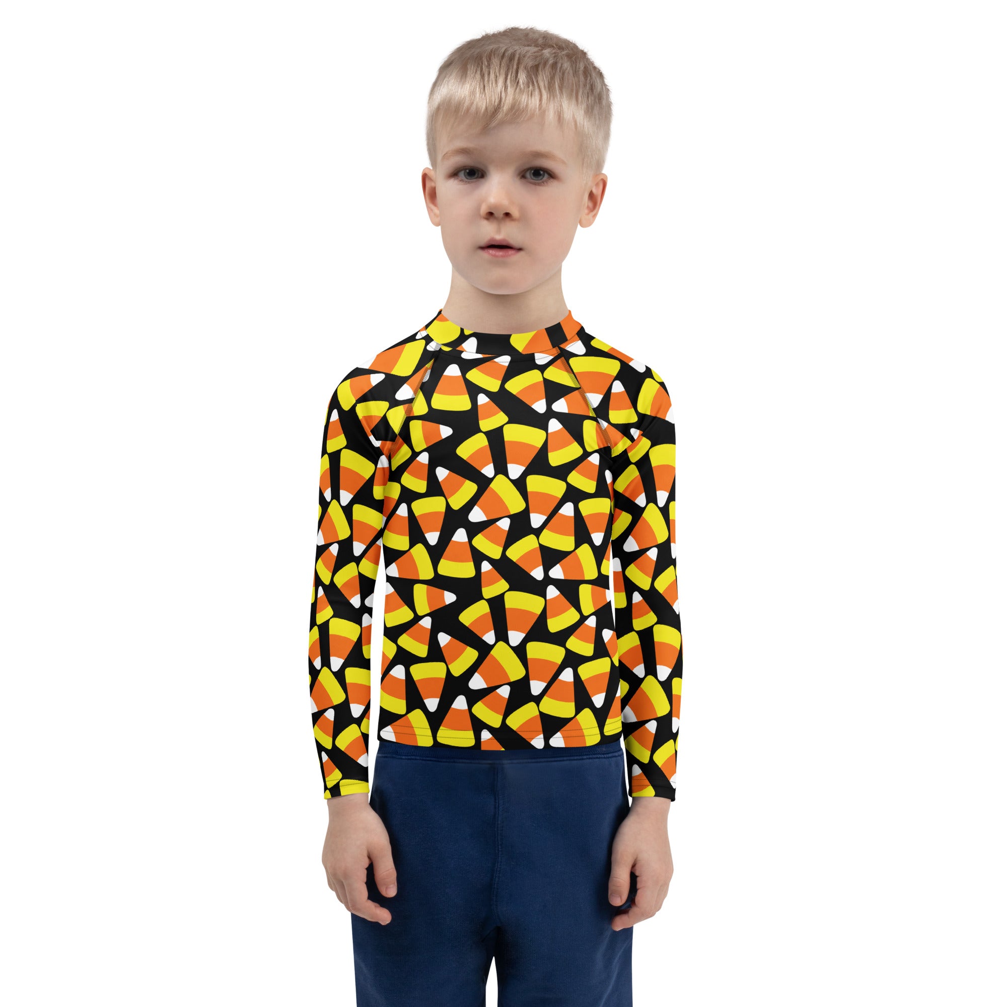 A child wearing a kids candy corn halloween long sleeve rash guard swim shirt with upf 50+ and candy corn pattern
