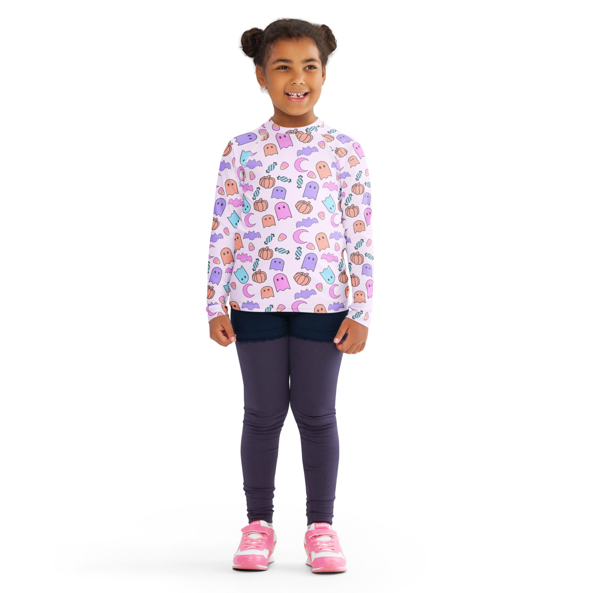 A child wearing a girls halloween pattern long sleeve rash guard swim shirt with upf 50 plus in light purple
