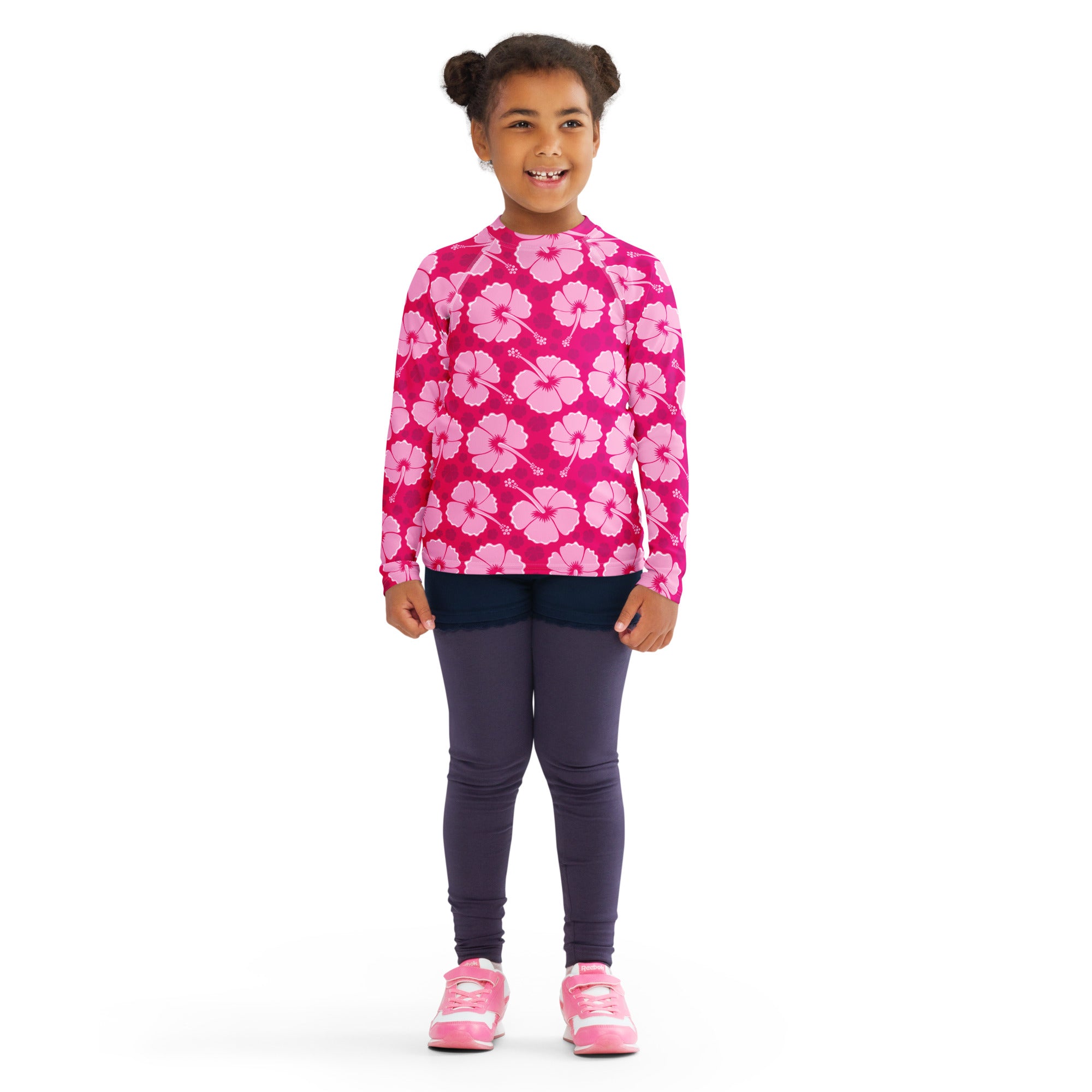Girls tropical pink hibiscus long sleeve rash guard swim shirt with UPF 50+ featuring light pink floral pattern