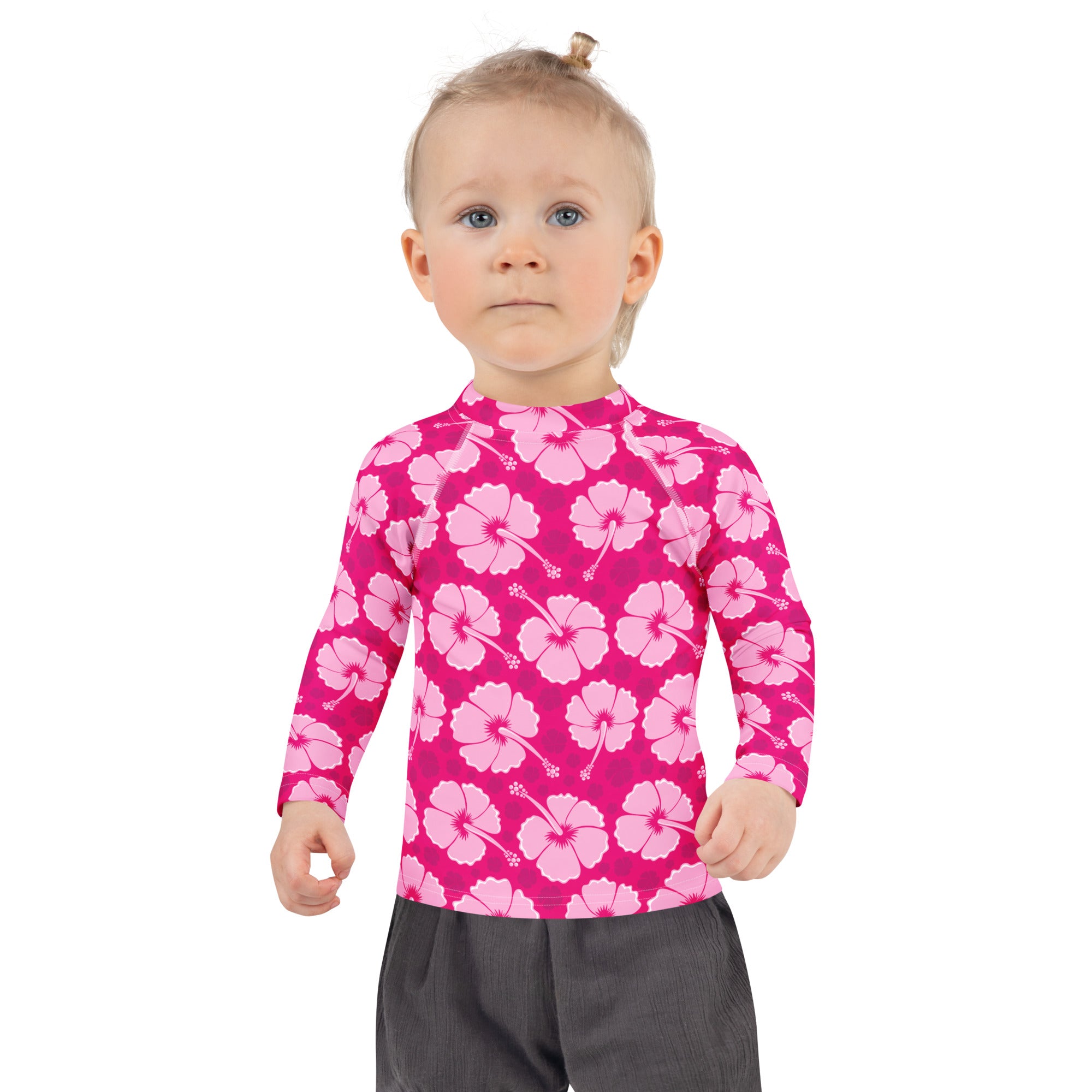 Bright pink girls long sleeve rash guard with light pink hibiscus pattern and UPF 50 plus sun protection