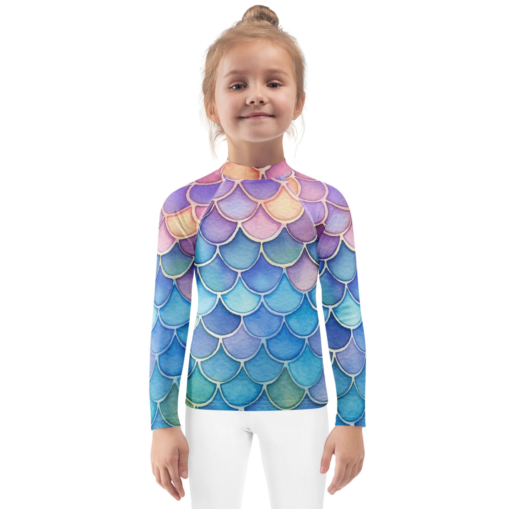 A girls long-sleeve rash guard with vibrant iridescent purple blue teal mermaid scales and upf 50+ protection