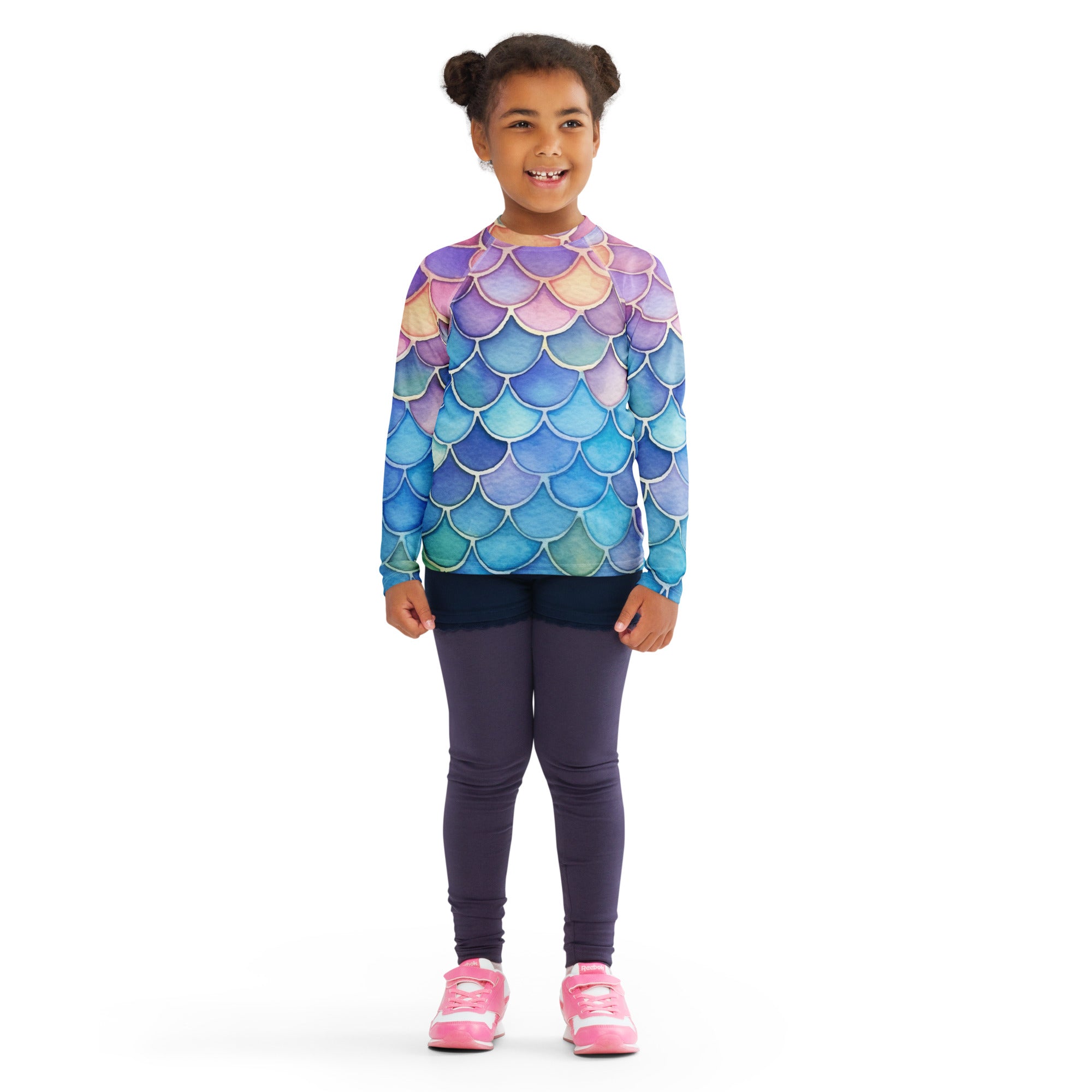 A child wearing a girls watercolor rainbow mermaid long sleeve rash guard swim shirt with upf 50+ in purple blue and teal