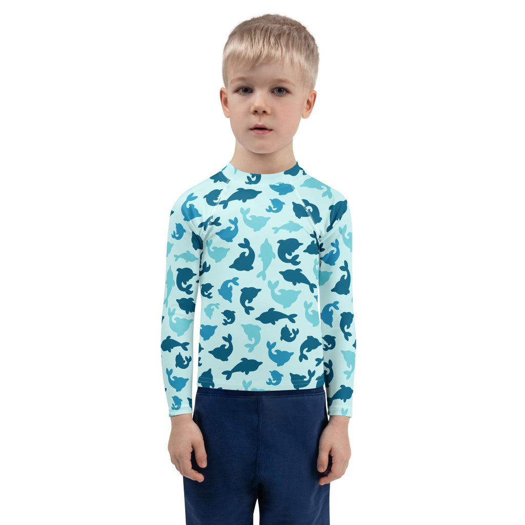 Light blue kids long sleeve rash guard with playful blue dolphin pattern and UPF 50 plus sun protection for swimming