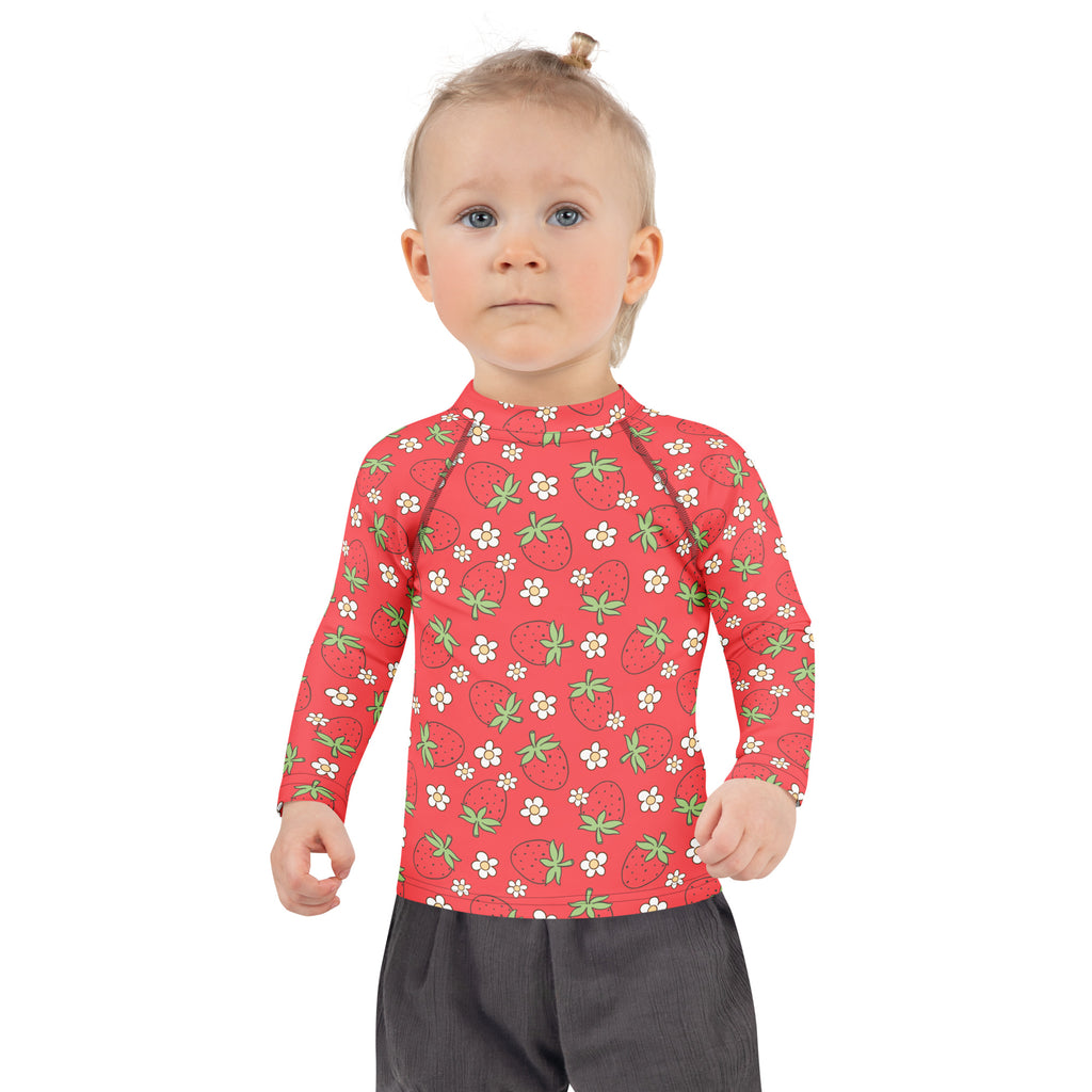 Kids red long sleeve rash guard swim shirt with strawberry and white flower pattern and UPF 50 plus protection