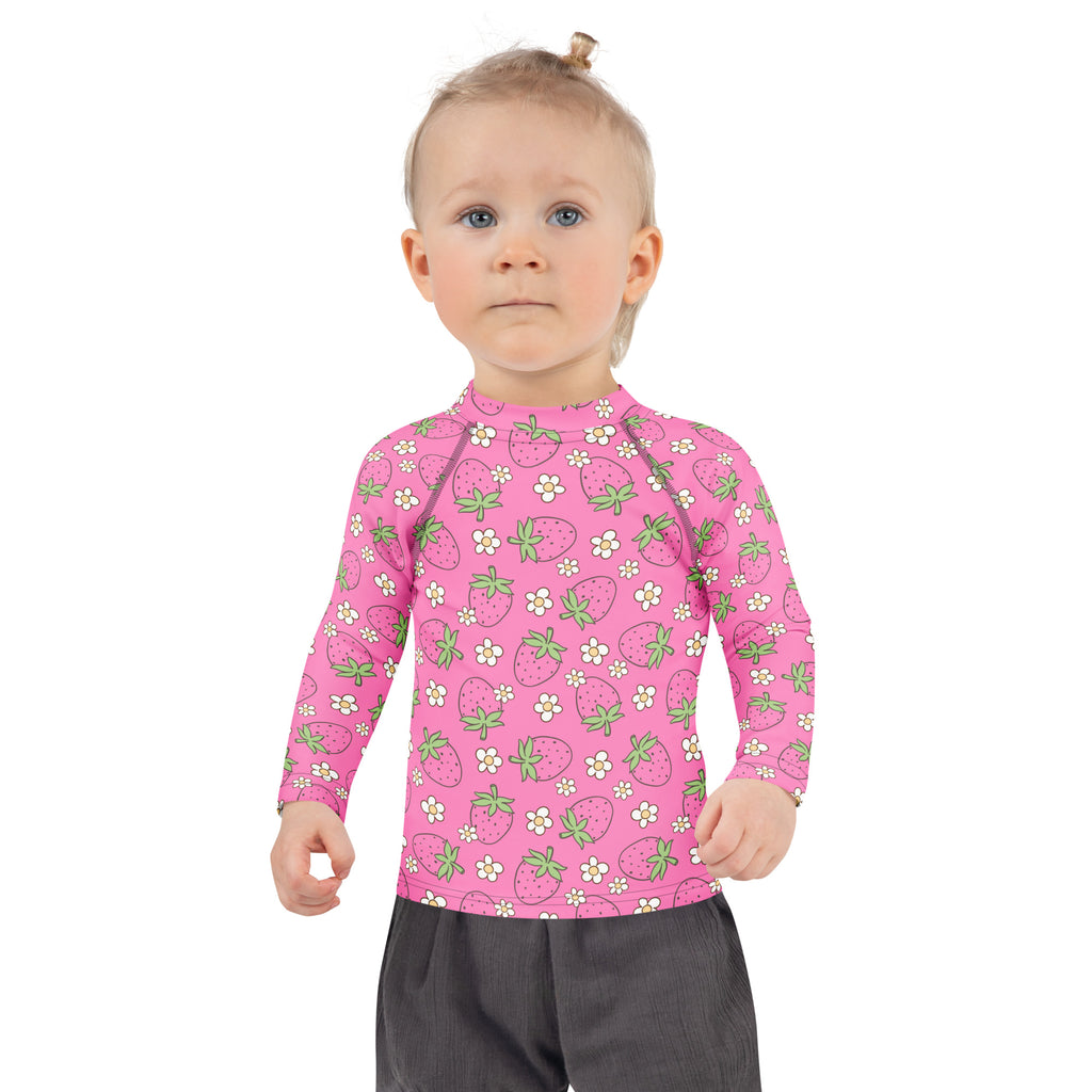 Girls pink long sleeve rash guard swim shirt with strawberry and white flower pattern and UPF 50 plus protection