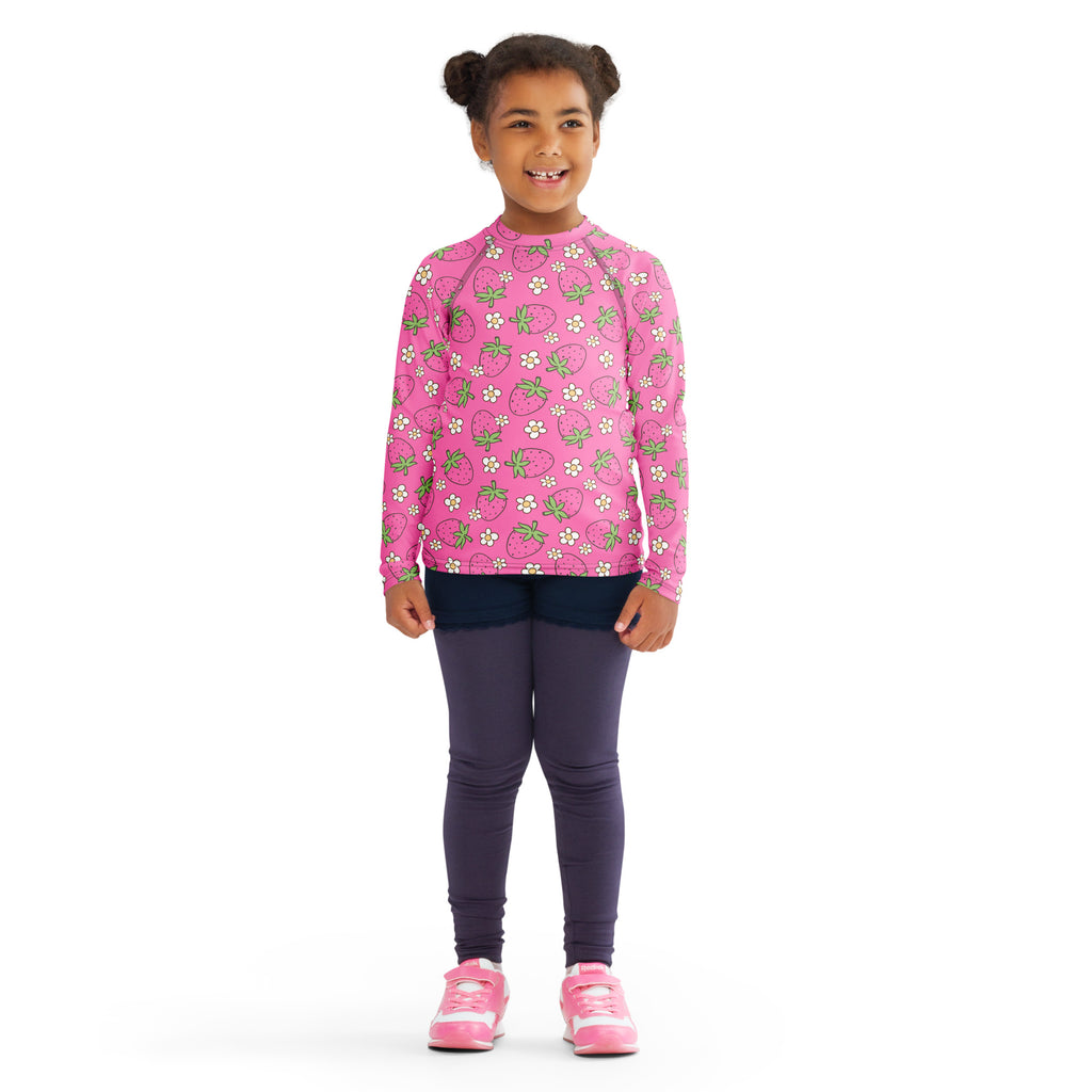Girls pink long sleeve rash guard swim shirt with strawberry and white flower pattern and UPF 50 plus protection