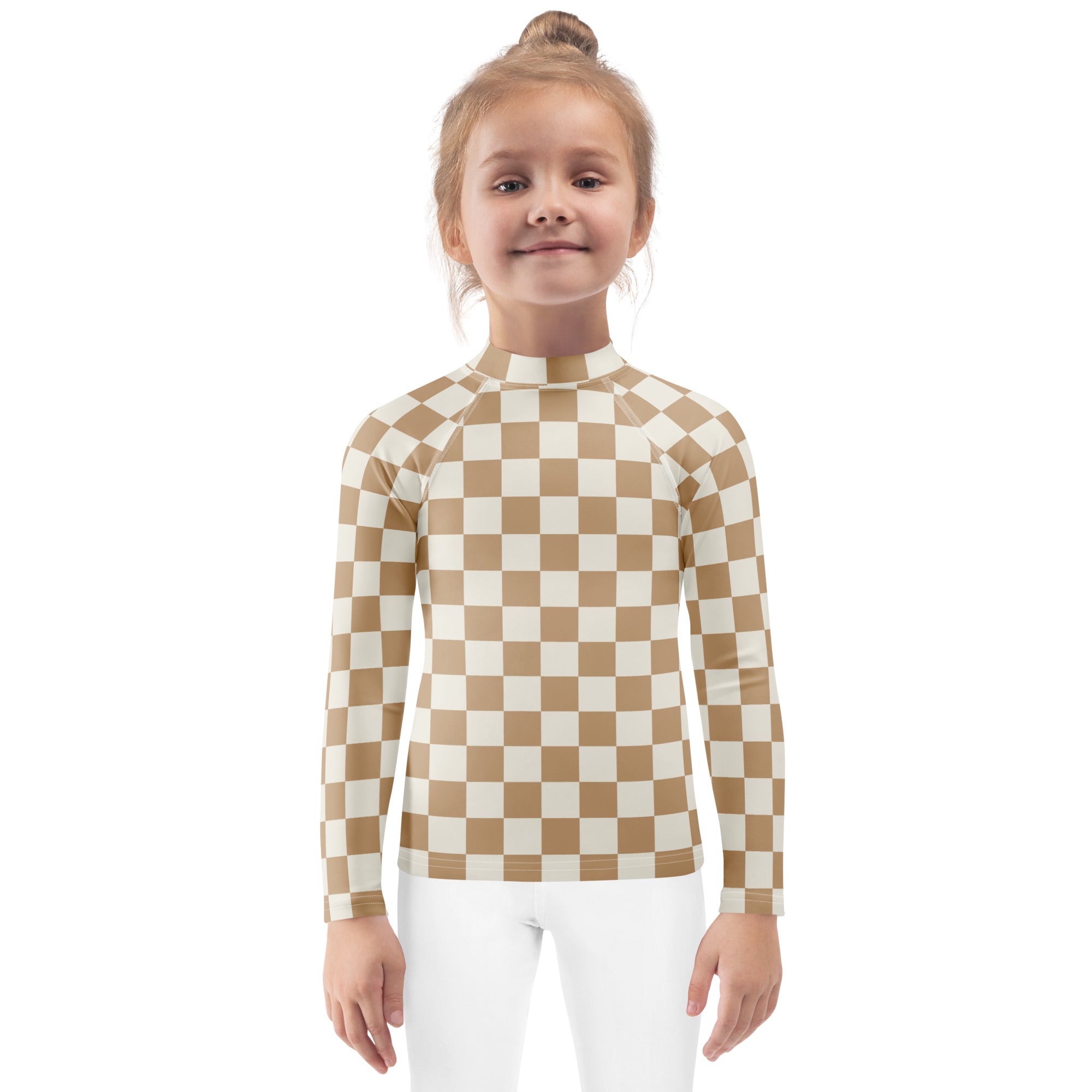 A child wearing a beige and cream checkered kids sand checkerboard long sleeve rash guard swim shirt with UPF 50+