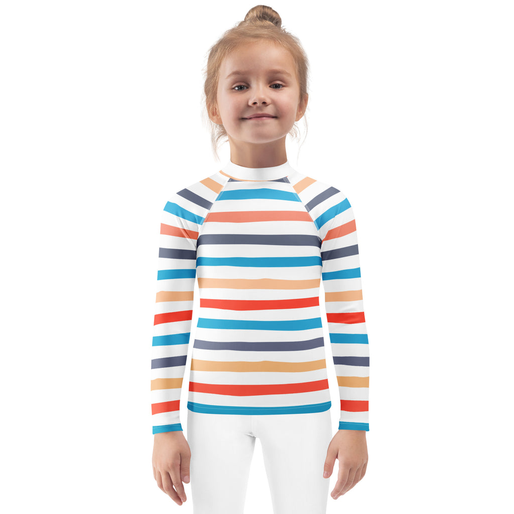 A child wearing a kids coastal stripes long sleeve rash guard swim shirt with upf 50 plus in vibrant orange and blue stripes