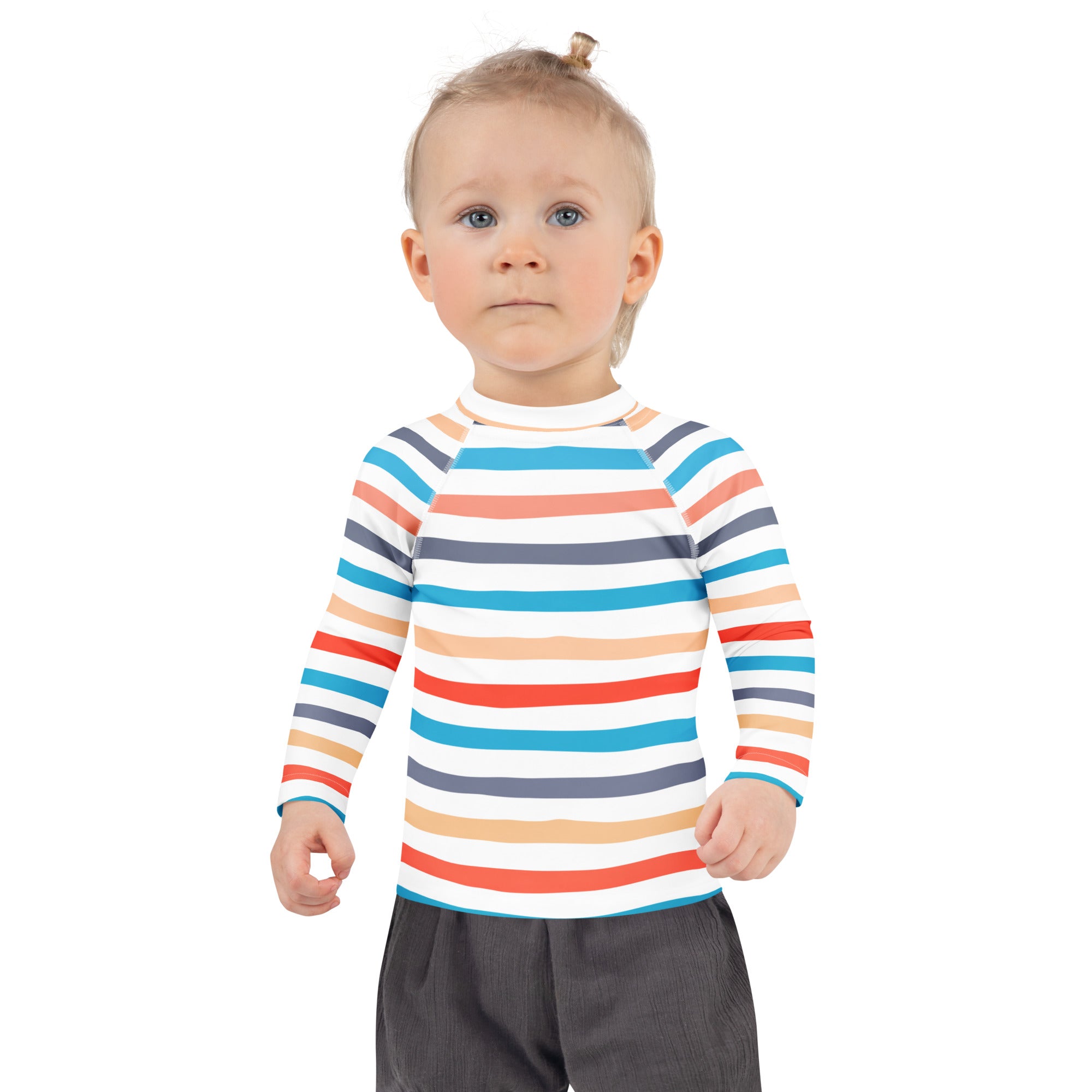 A child wearing a kids coastal stripes long sleeve rash guard swim shirt with colorful stripes and UPF 50 plus protection