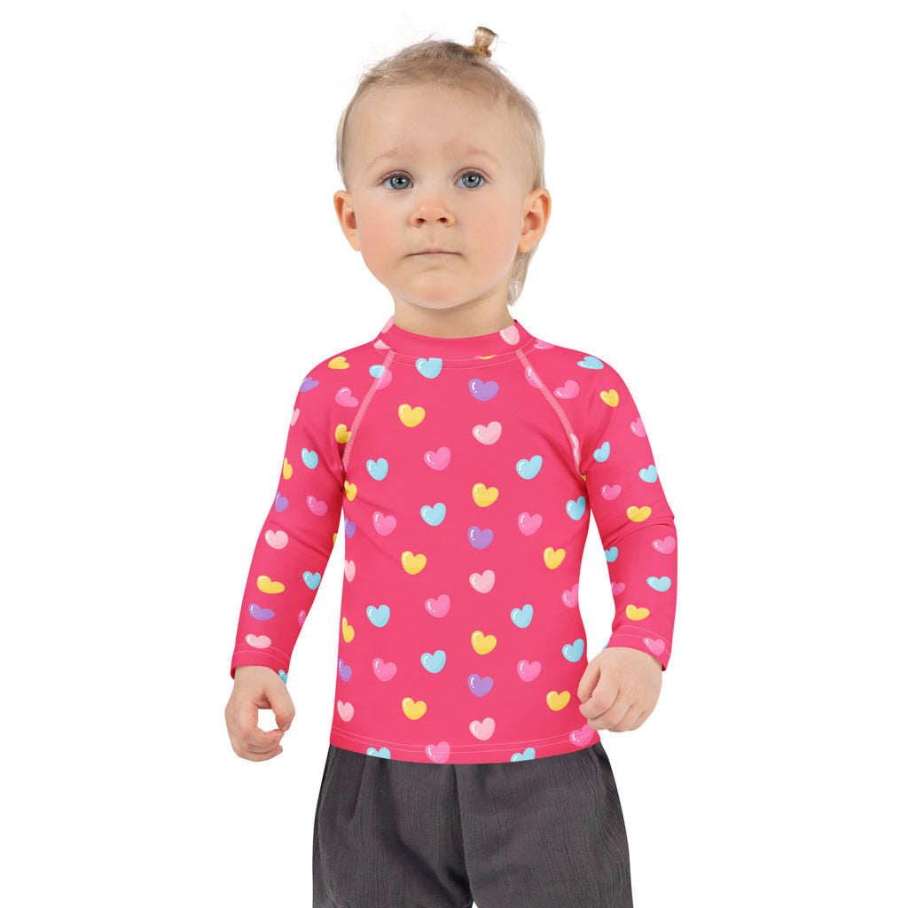 Girls colorful hearts pink long sleeve rash guard swim shirt with UPF 50 plus featuring multicolored heart pattern