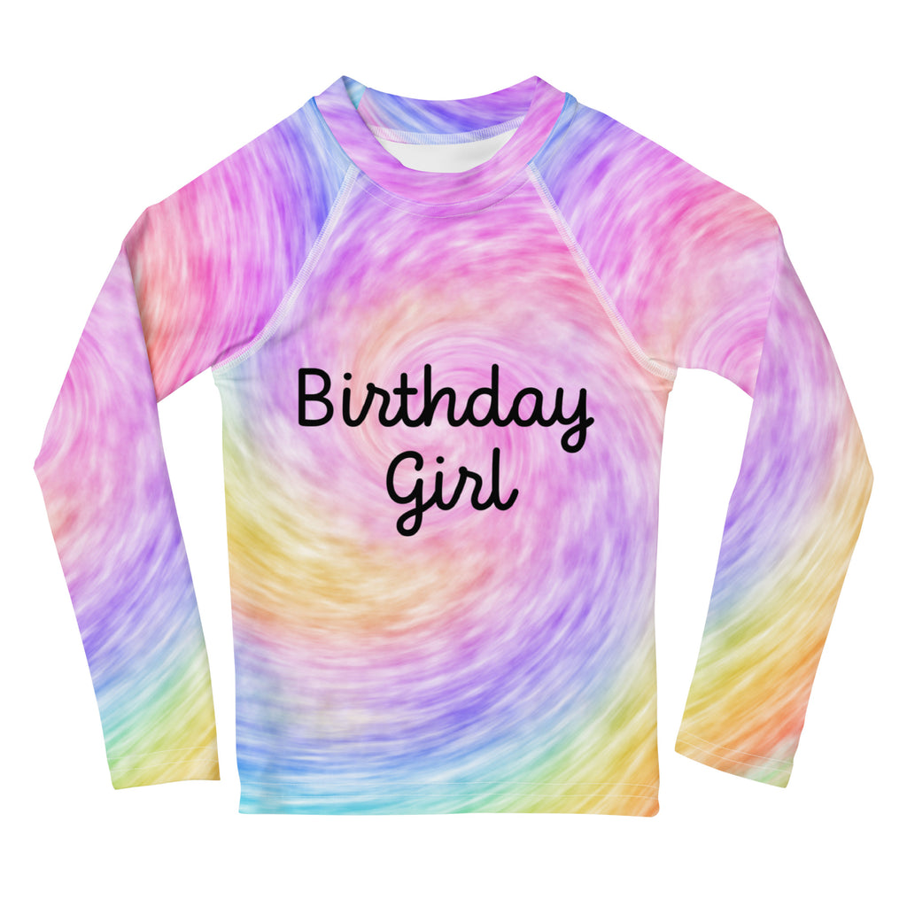 A vibrant rainbow swirl girls long sleeve rash guard with birthday girl in black cursive and UPF 50 plus protection